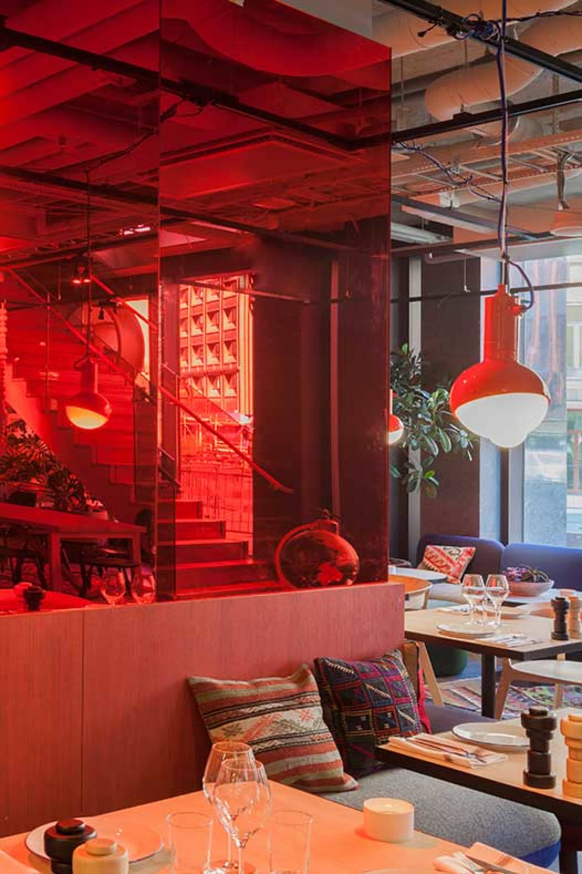 Modern industrial restaurant interior with glass, steel, and wooden accents.