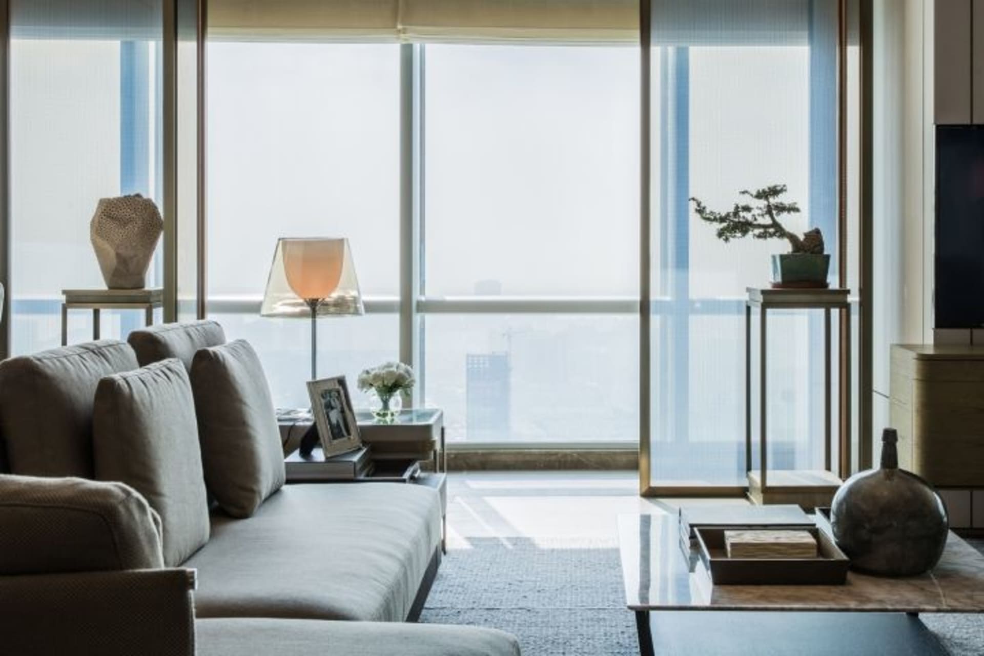 Contemporary living room featuring floor-to-ceiling glass windows.