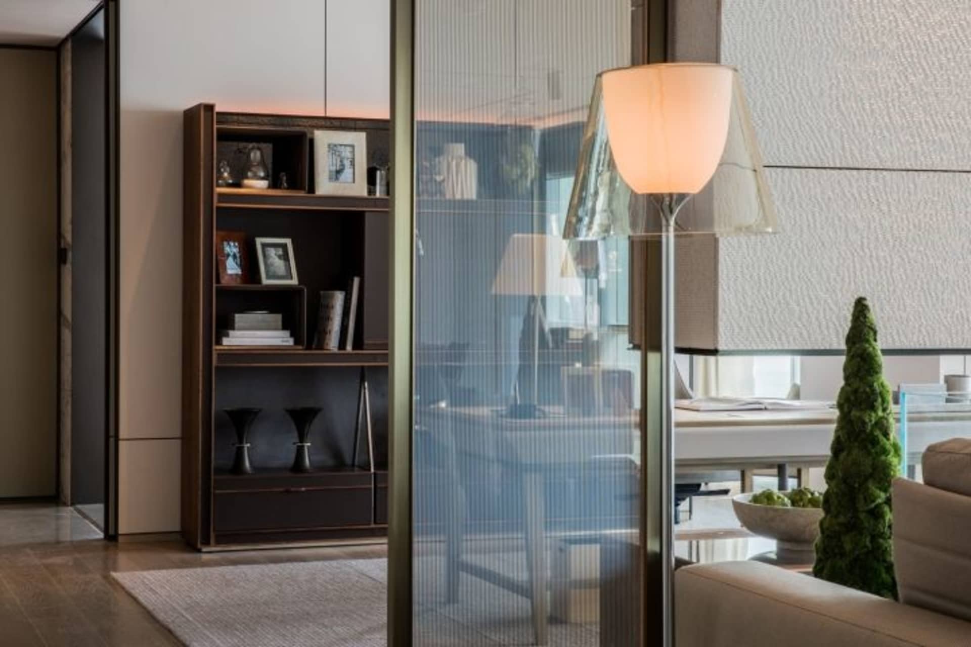 Modern interior design featuring a living room with wood, acrylic, and glass materials