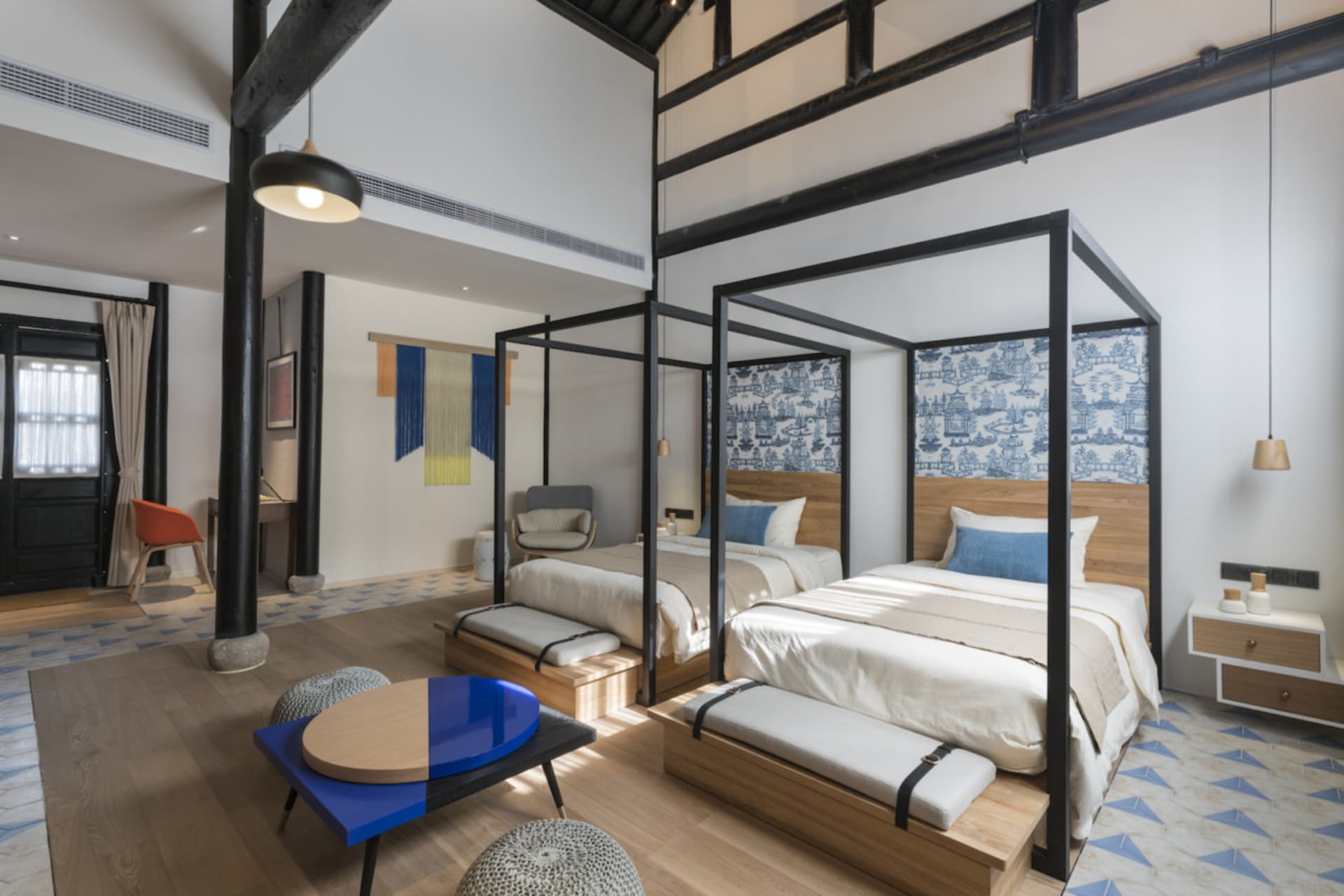 A minimalist residential room with wooden furniture and metal accents.