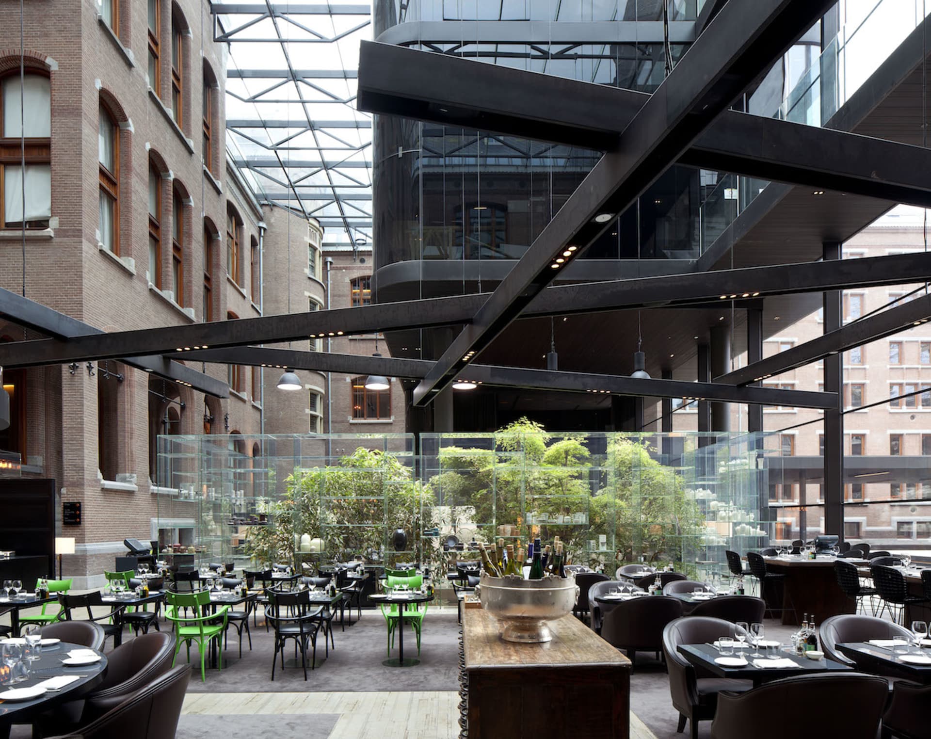 A stylish, modern cafeteria with glass walls and concrete flooring.