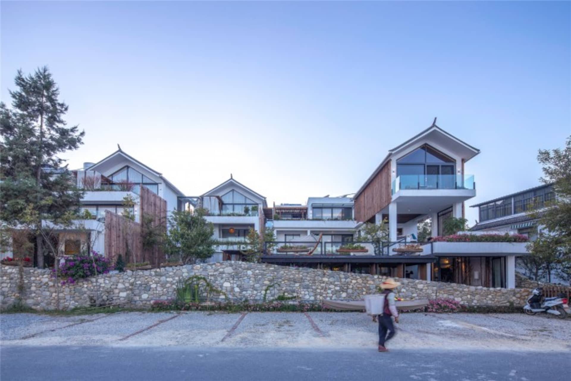 A modern residential exterior made of stone and wood