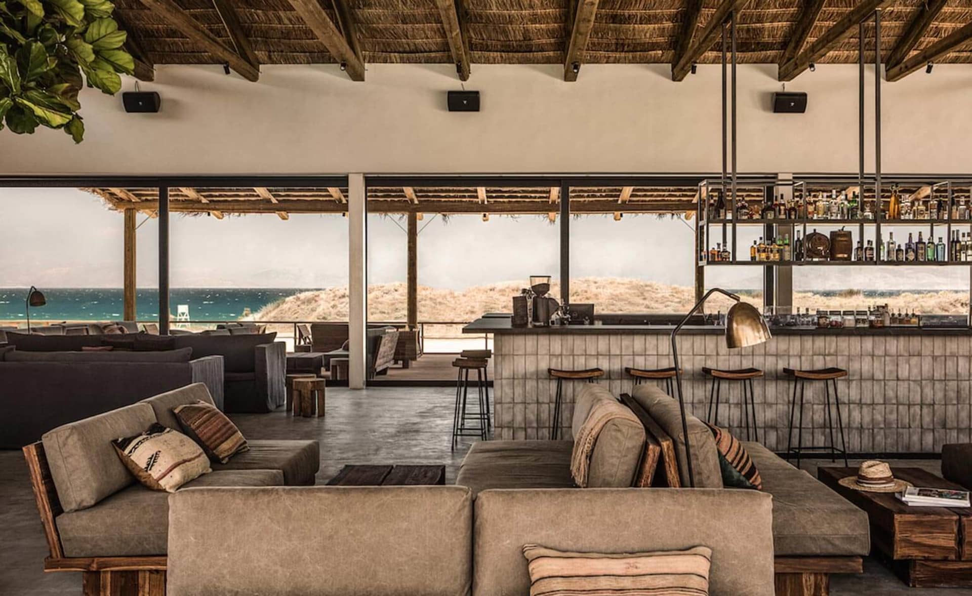 Industrial restaurant interior with concrete walls, wooden tables, and metal accents.