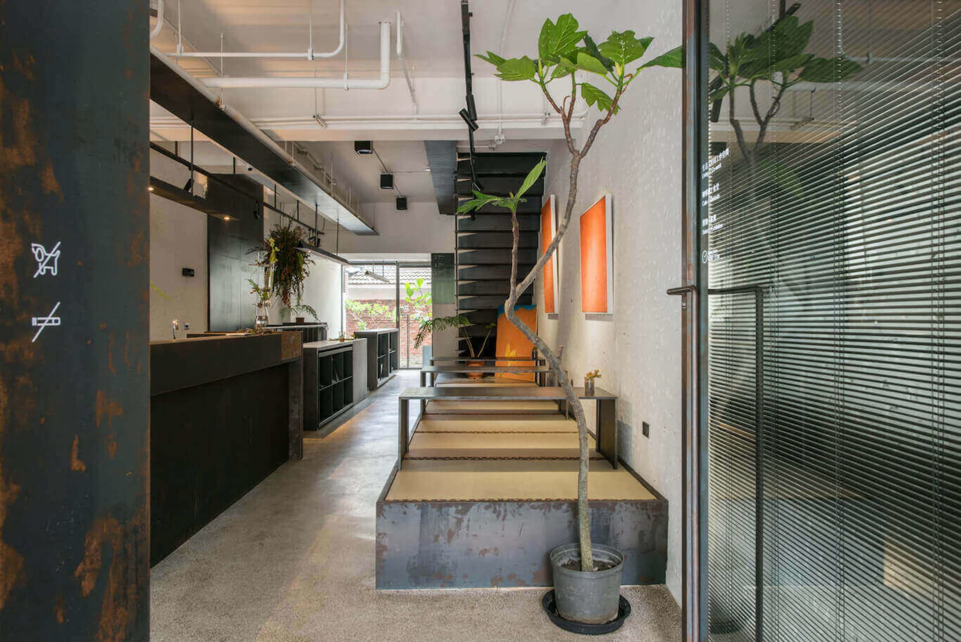 Modern industrial coffee shop interior with metal and wood elements.