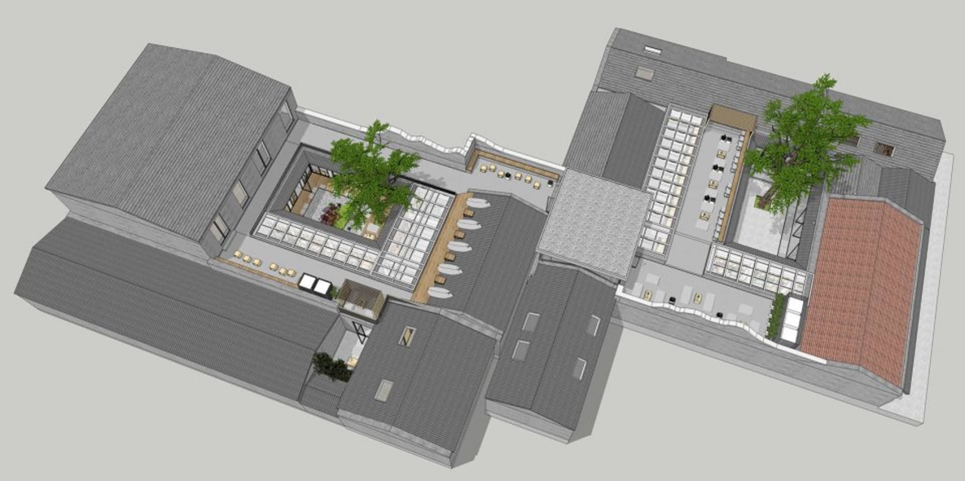 Aerial view of an urban rooftop terrace featuring concrete, glass, and wooden elements.