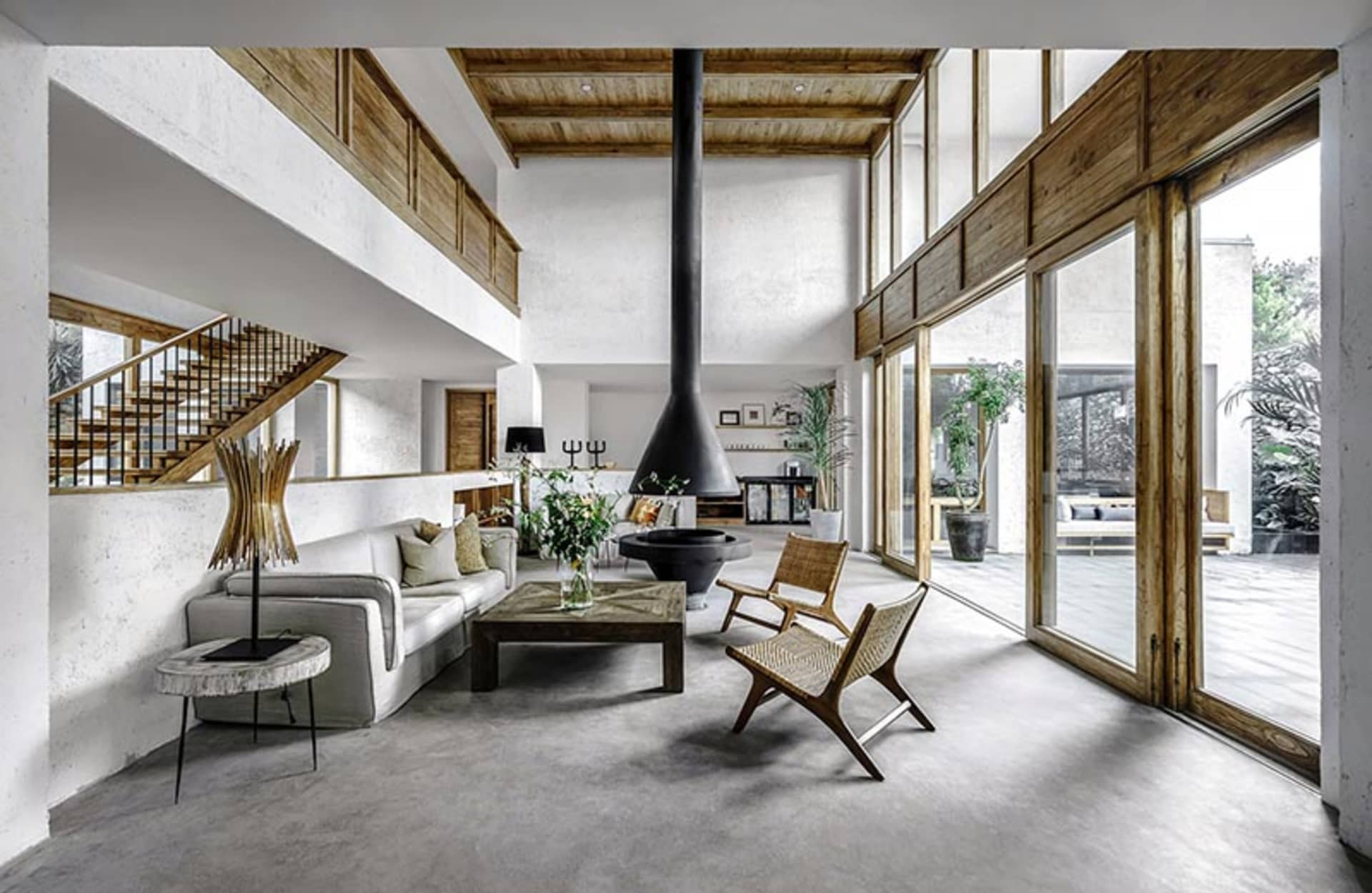 Modern interior design featuring a concrete floor and wooden furniture in a living room setting.