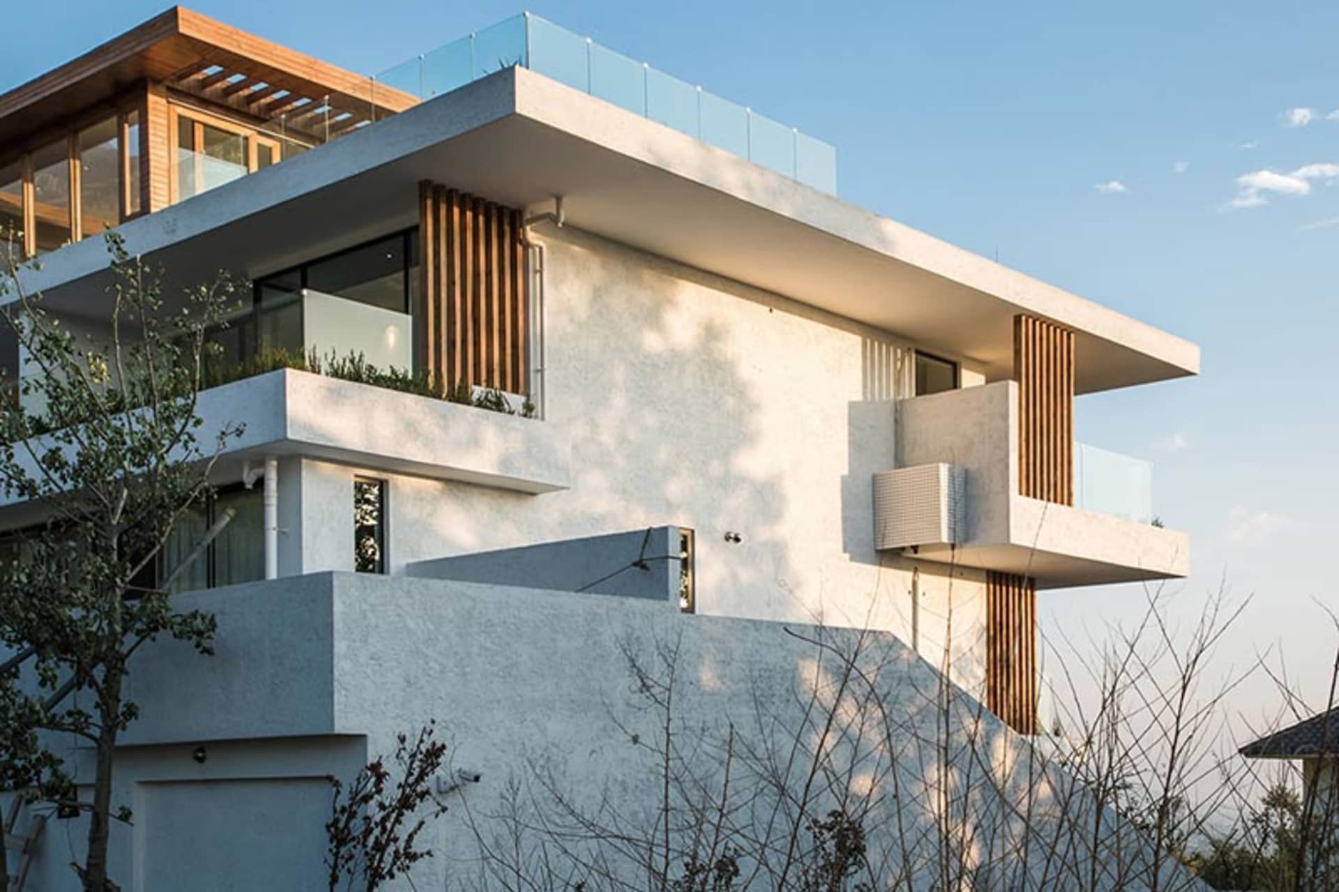 Modern house featuring concrete, glass, and wood materials.