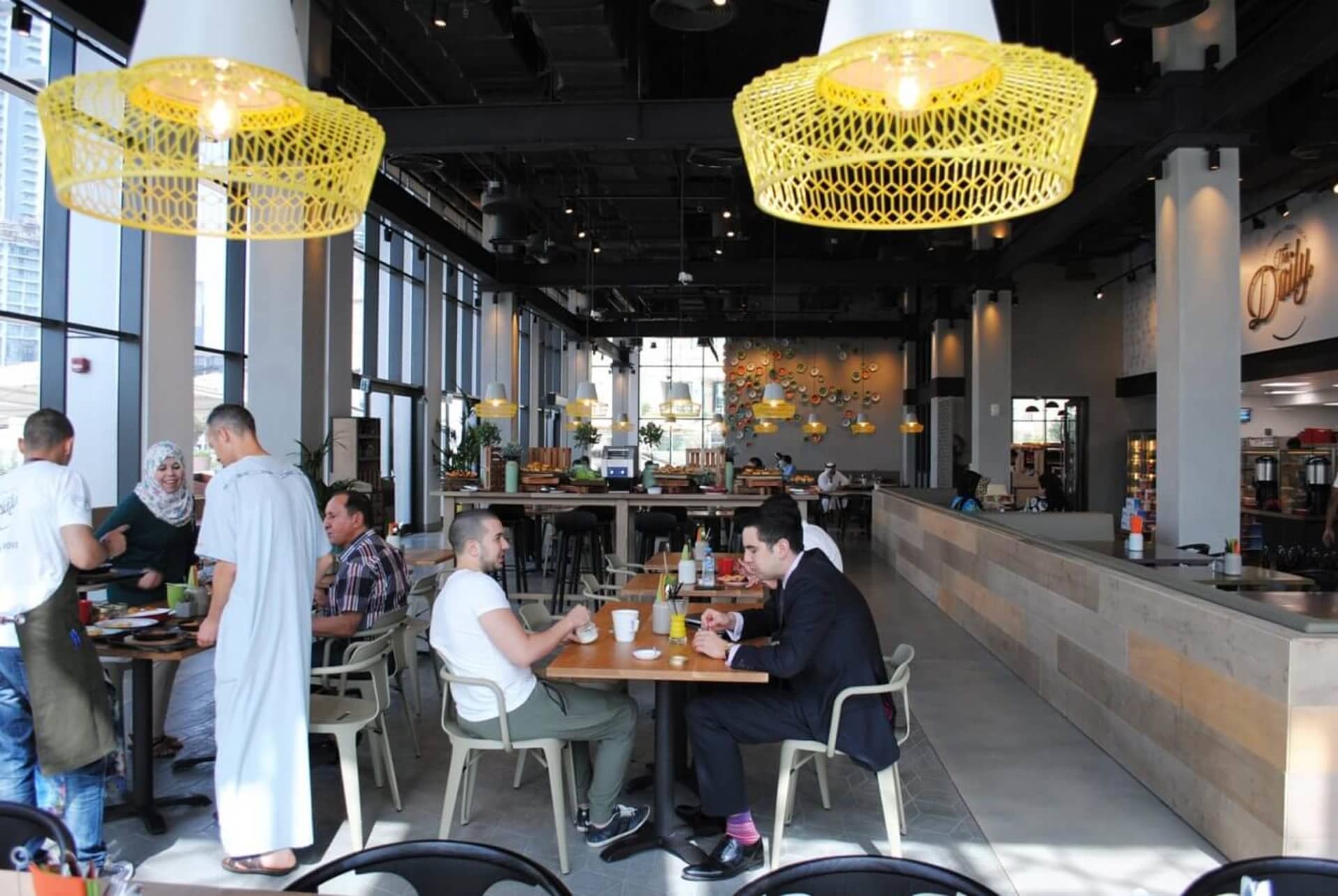 Industrial-style restaurant interior with metallic pendant lights and modern design