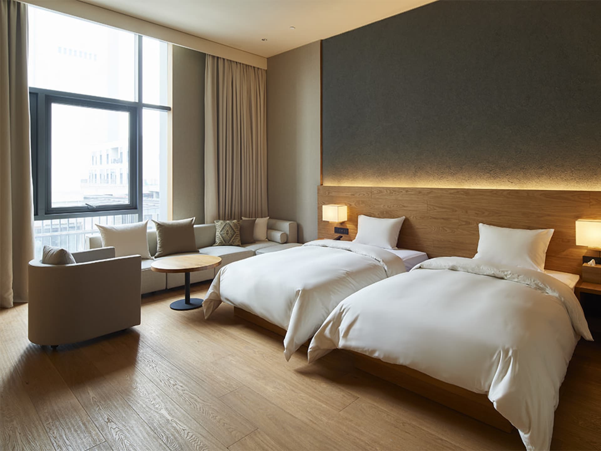 Modern, minimalist bedroom with twin beds, white bedding, and a contemporary design.