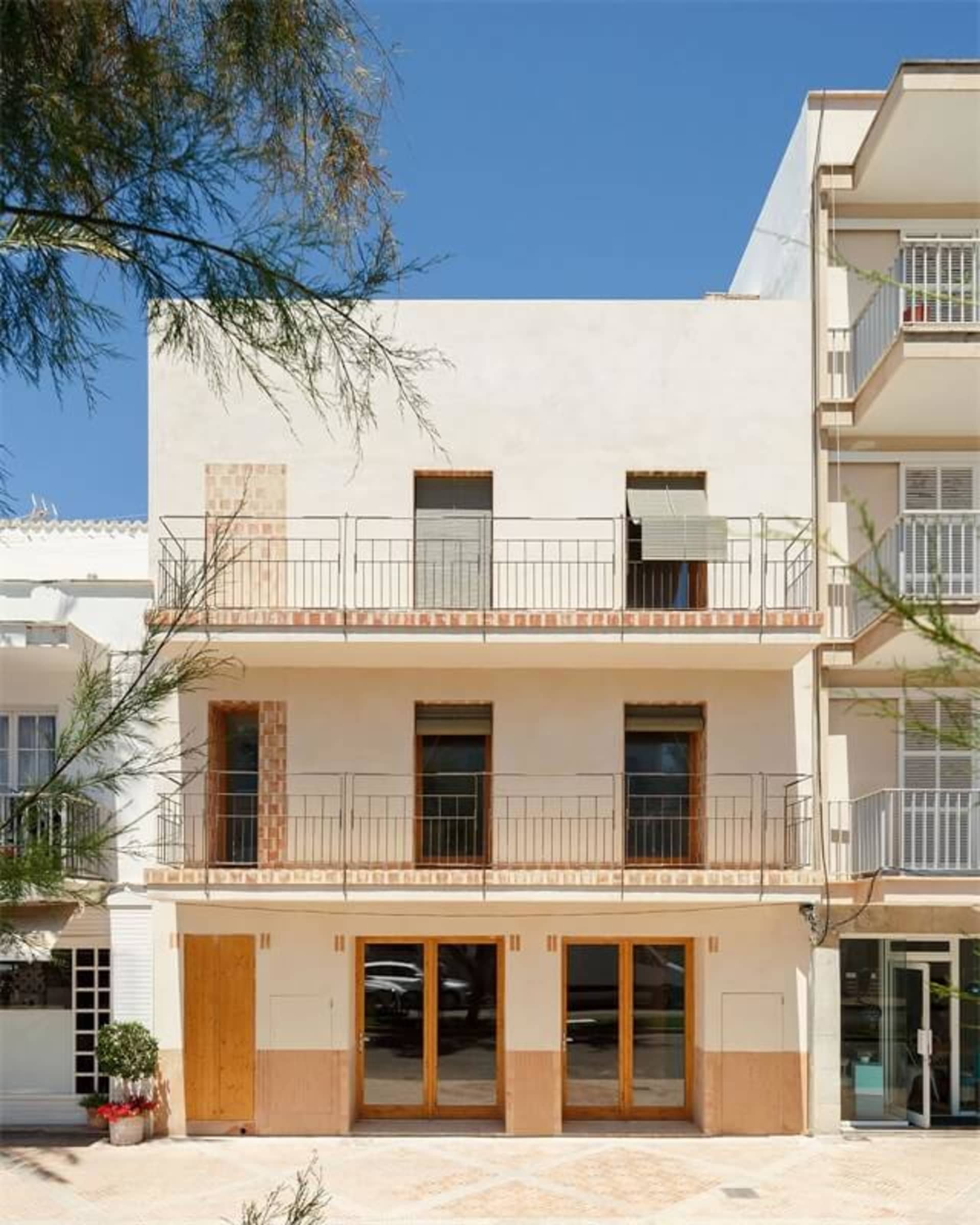 Modern residential building with sandstone, brick, and concrete materials.