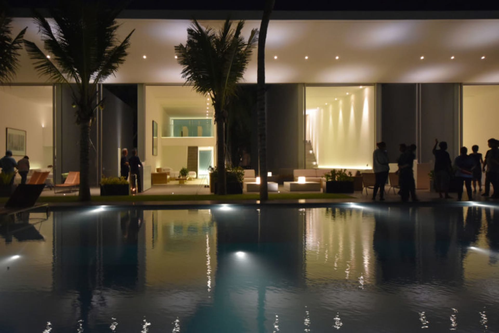 A modern residential living space featuring concrete and glass materials.