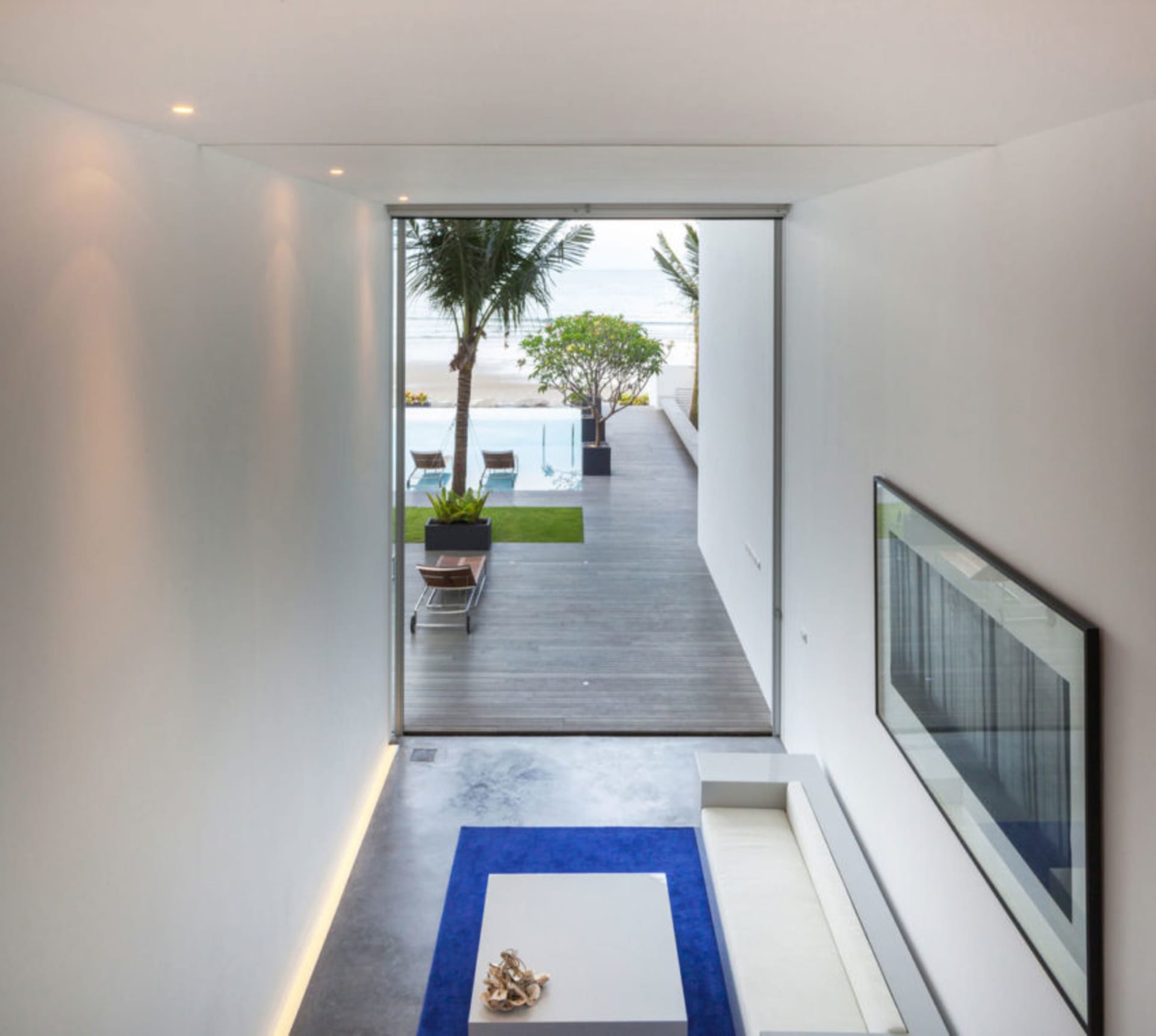 A modern residential entryway featuring a concrete floor and minimalist design.