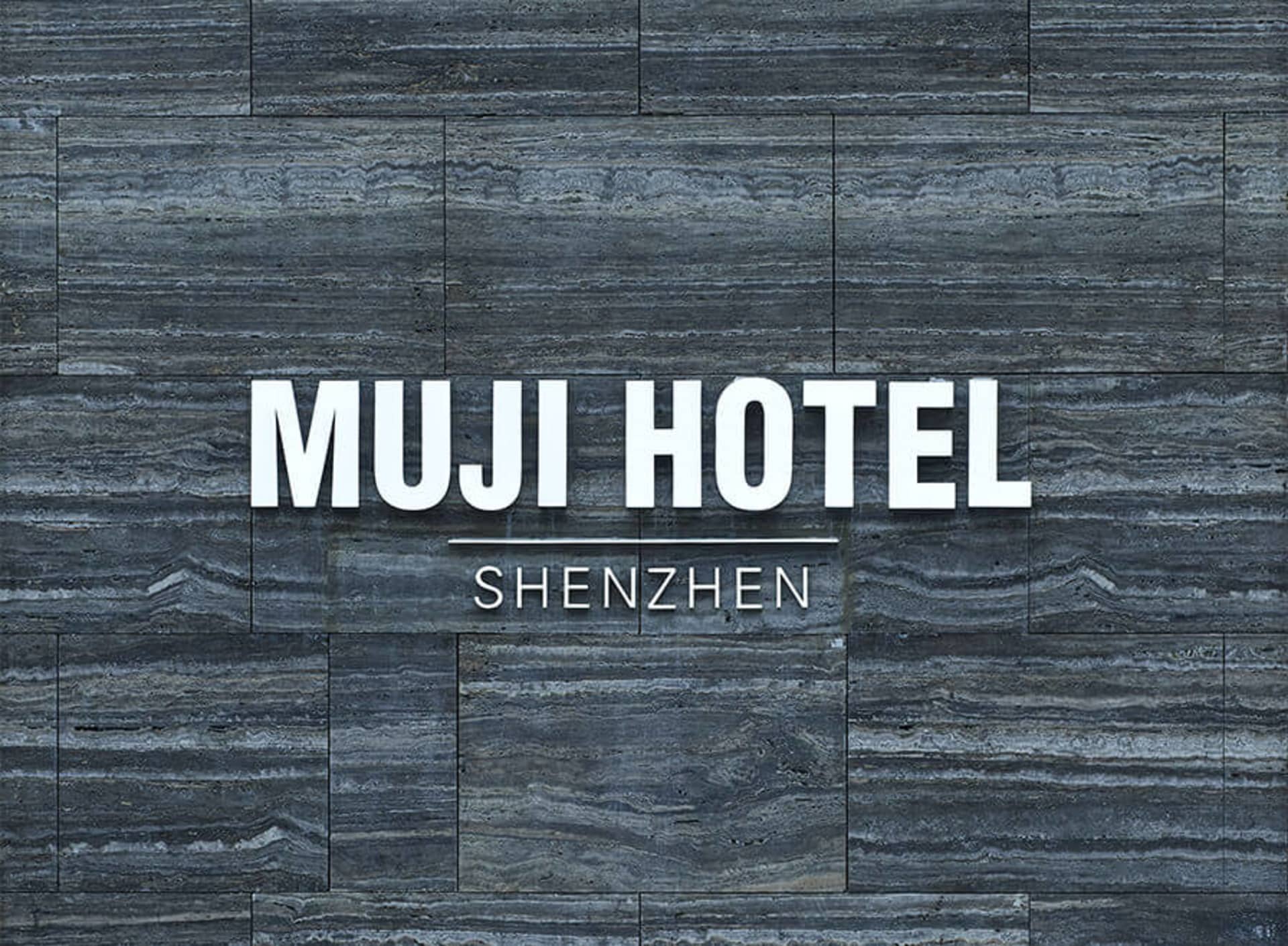 MUJI HOTEL SHENZHEN Interior with stone wall background