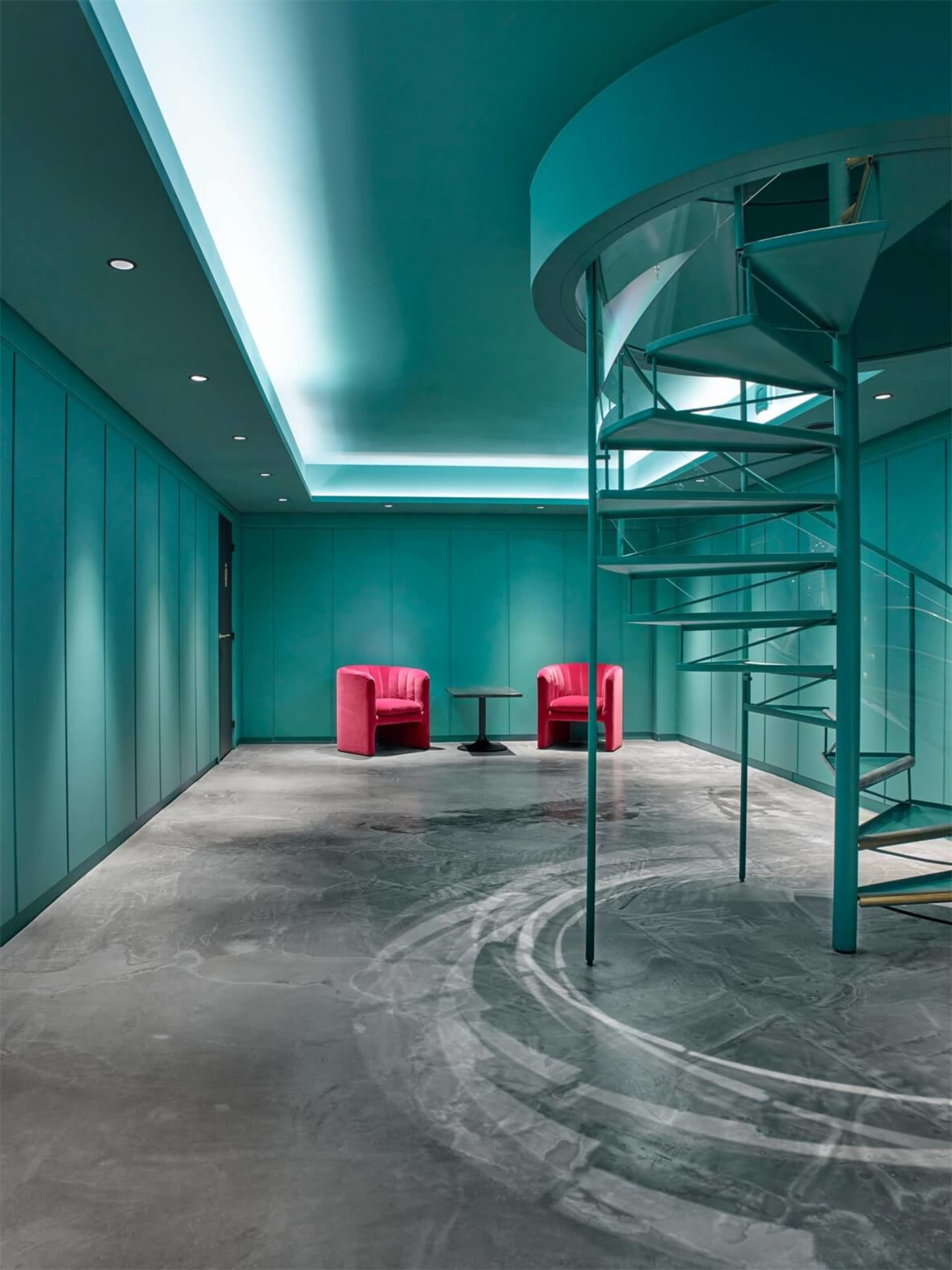 Modern office lounge featuring metal and concrete materials.