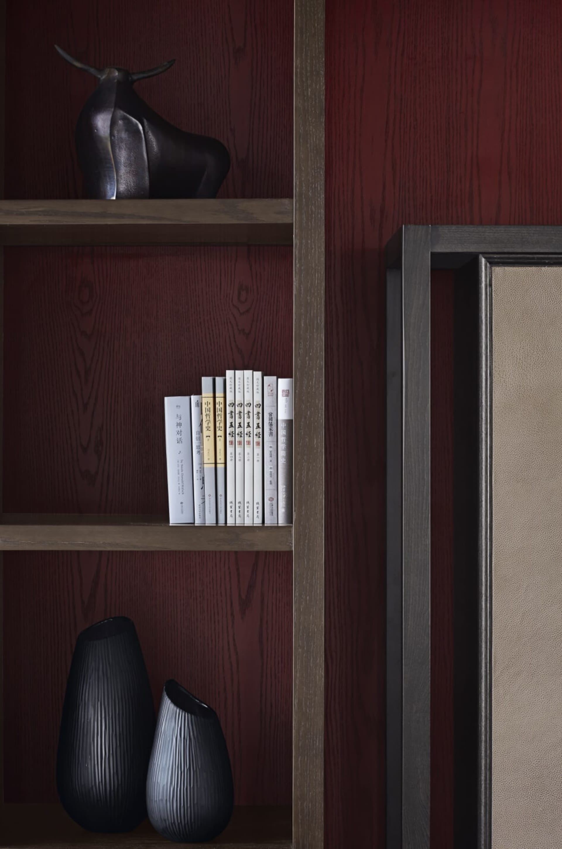 A modern interior with minimalist design features a wooden shelving unit.