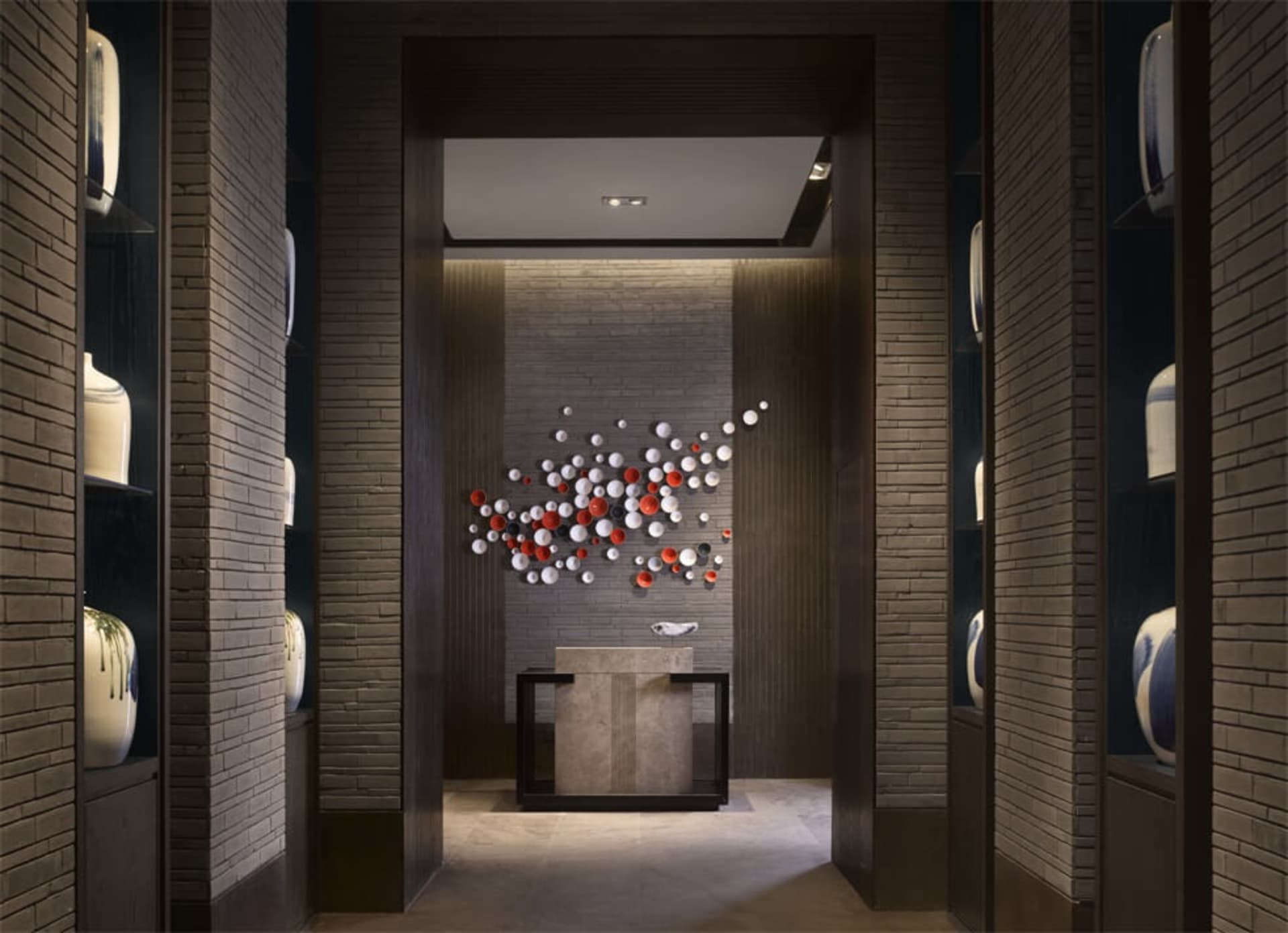 A modern lobby featuring stone walls and ceramic tiles
