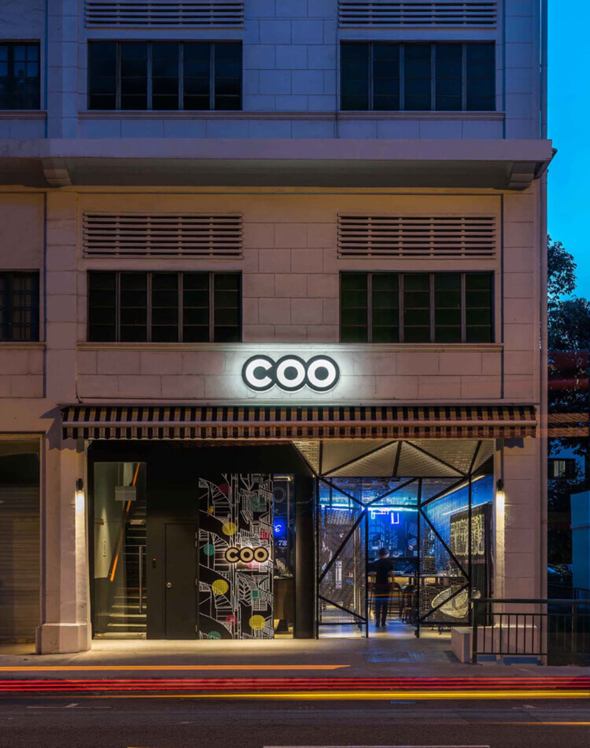 Modern storefront entrance with concrete texture and colorful patterns