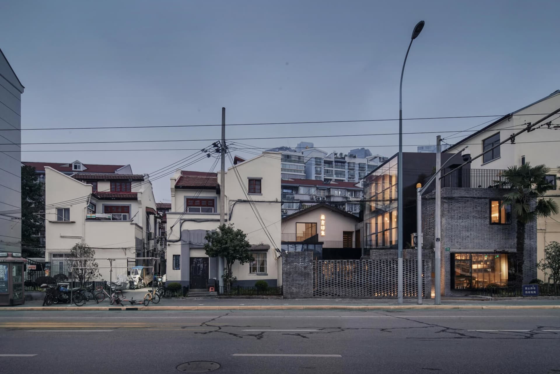 A city street corner featuring a modern retail shop with brick walls, glass windows, and concrete flooring.