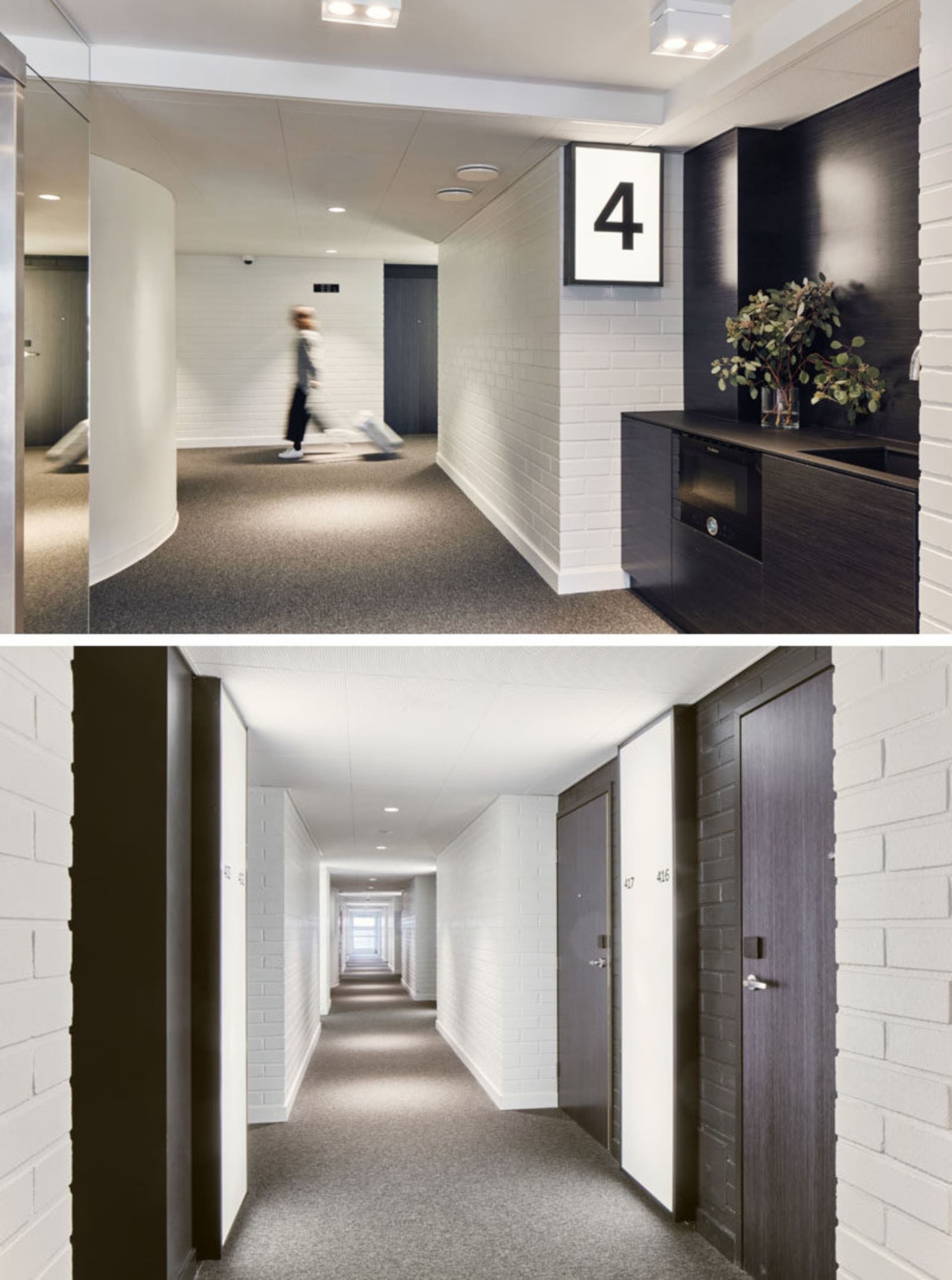 Floor-to-ceiling view of a modern corridor featuring a white brick wall, gray carpeted floor, black doors, and a black kitche