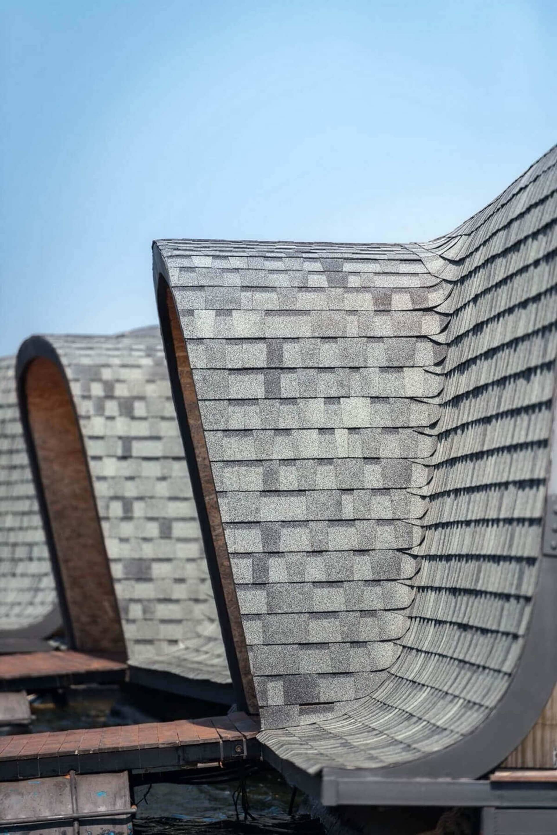 A close-up view of a floating roof with composite roof tiles on a clear day.