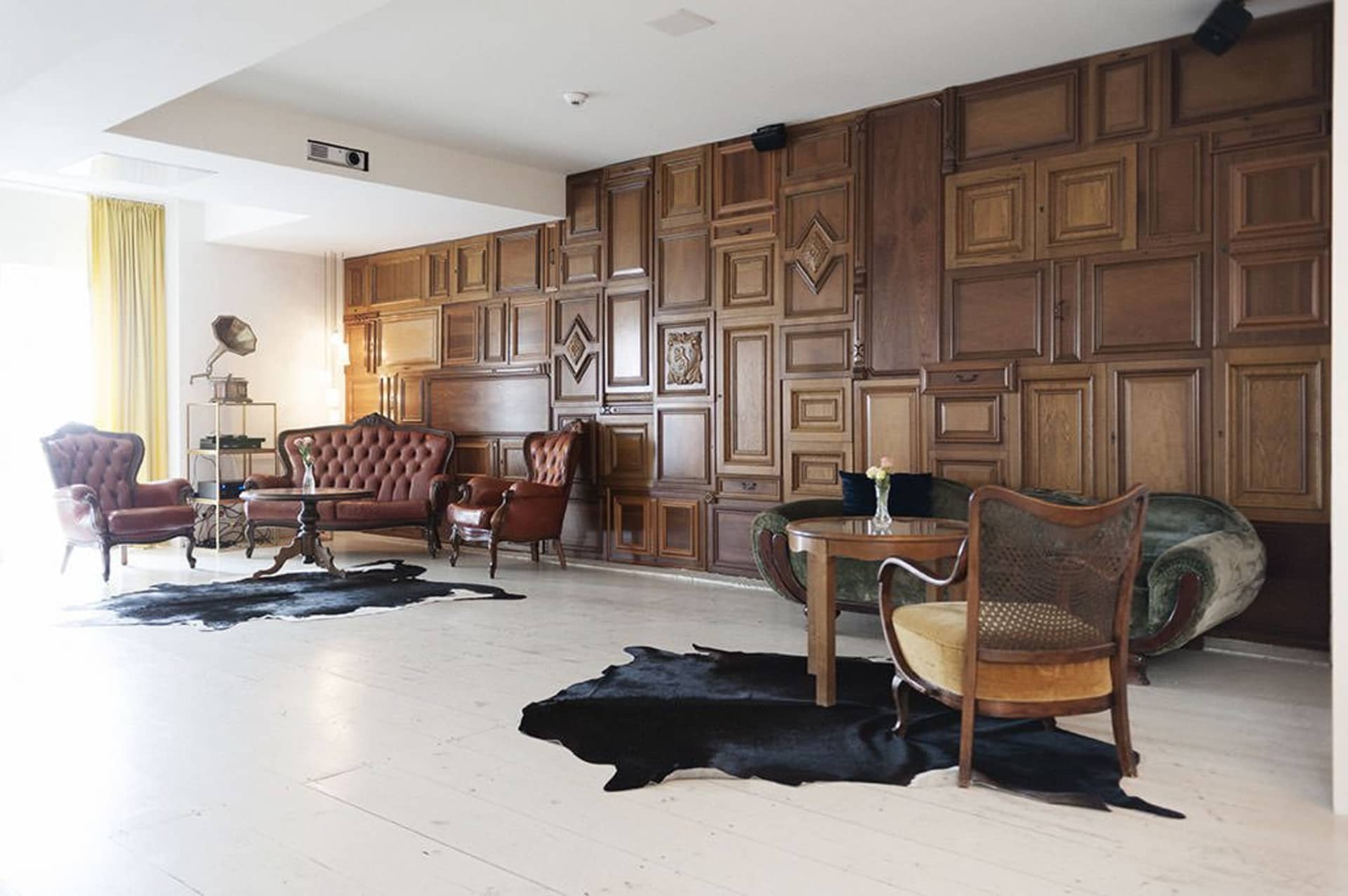 A modern industrial living room with wooden walls and furniture.