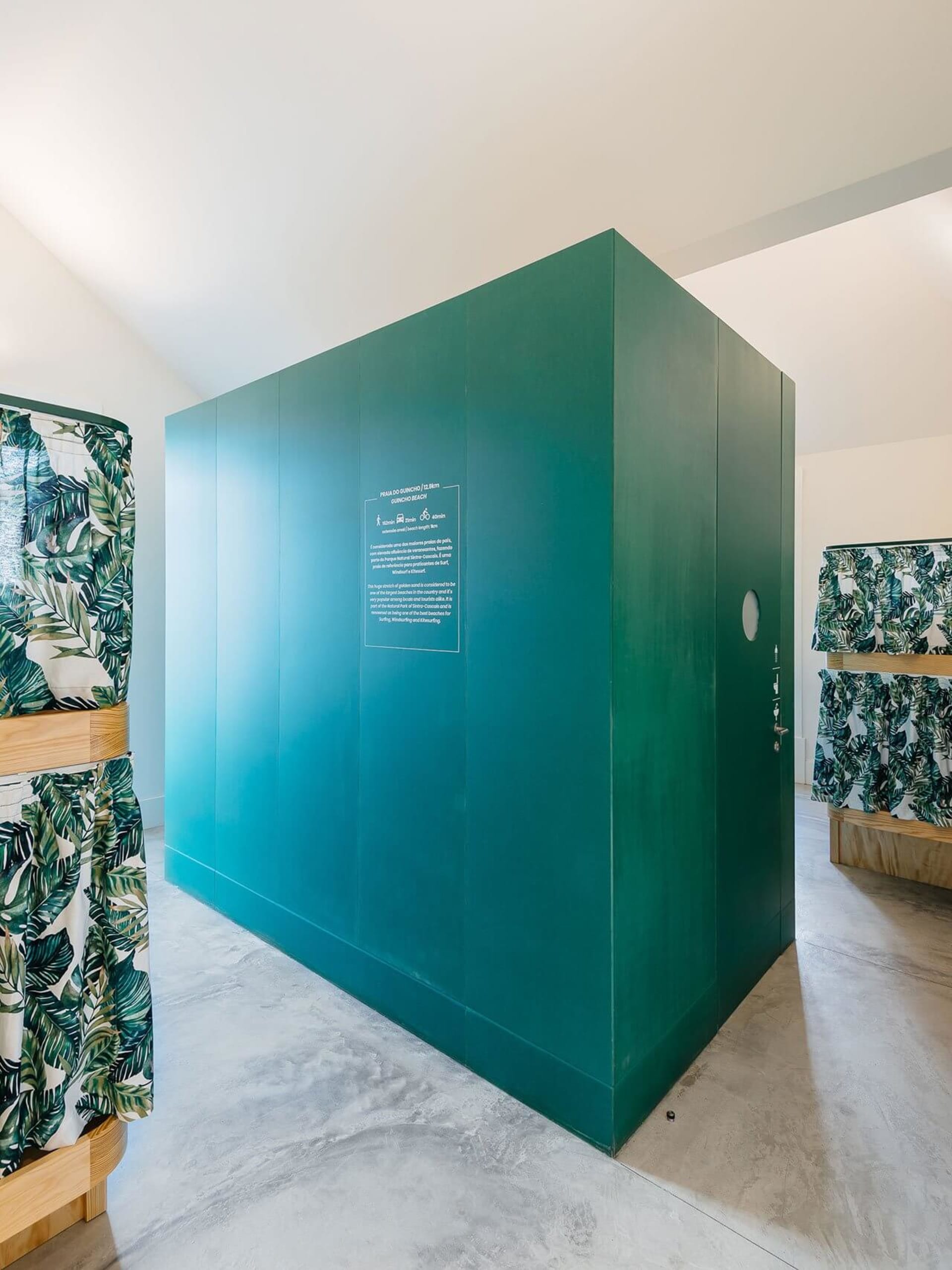 Minimalist public utility space with metallic green-tinted panels.
