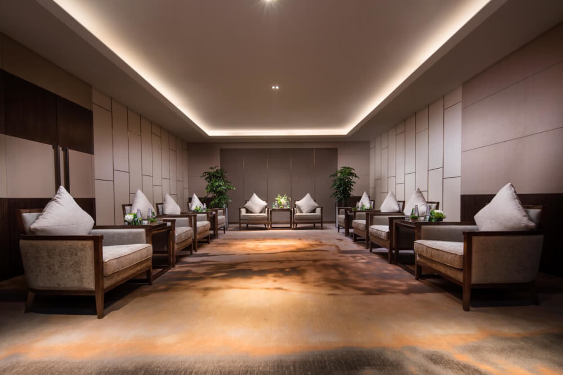A modern furniture showroom featuring plush, textured fabric armchairs and sofas.