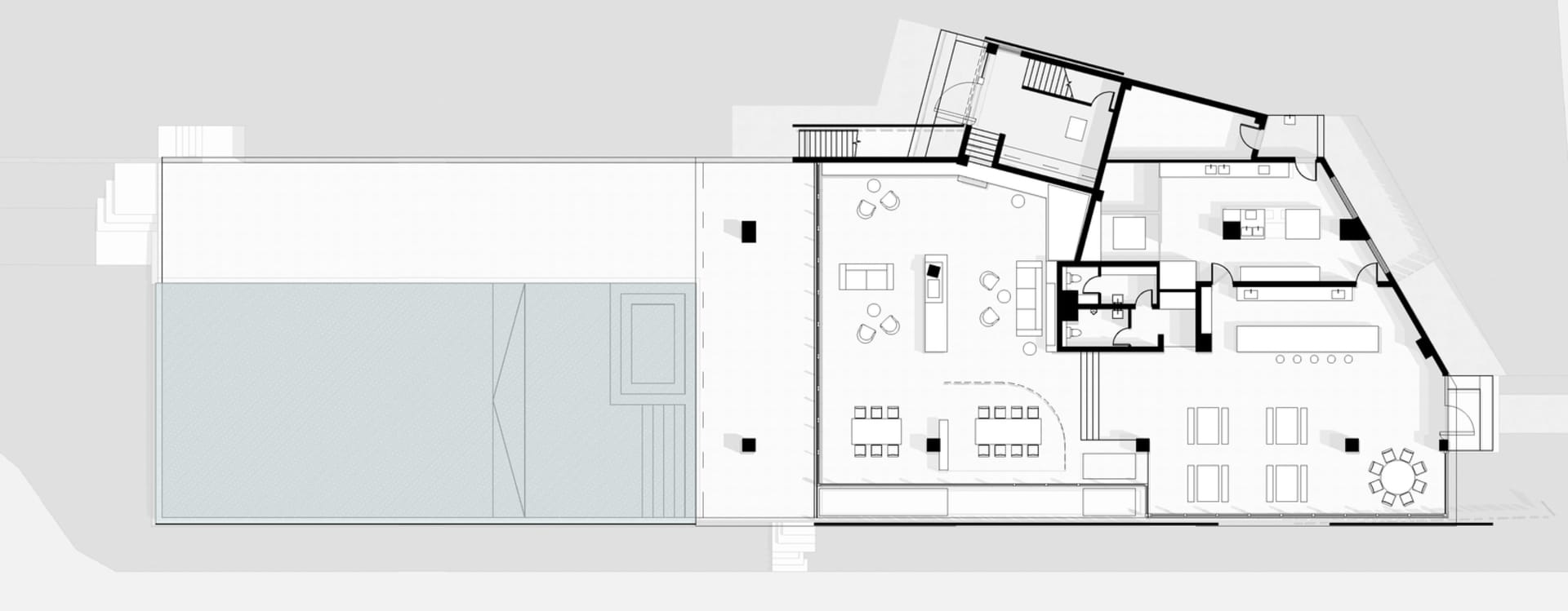 A modern office space plan featuring concrete elements.
