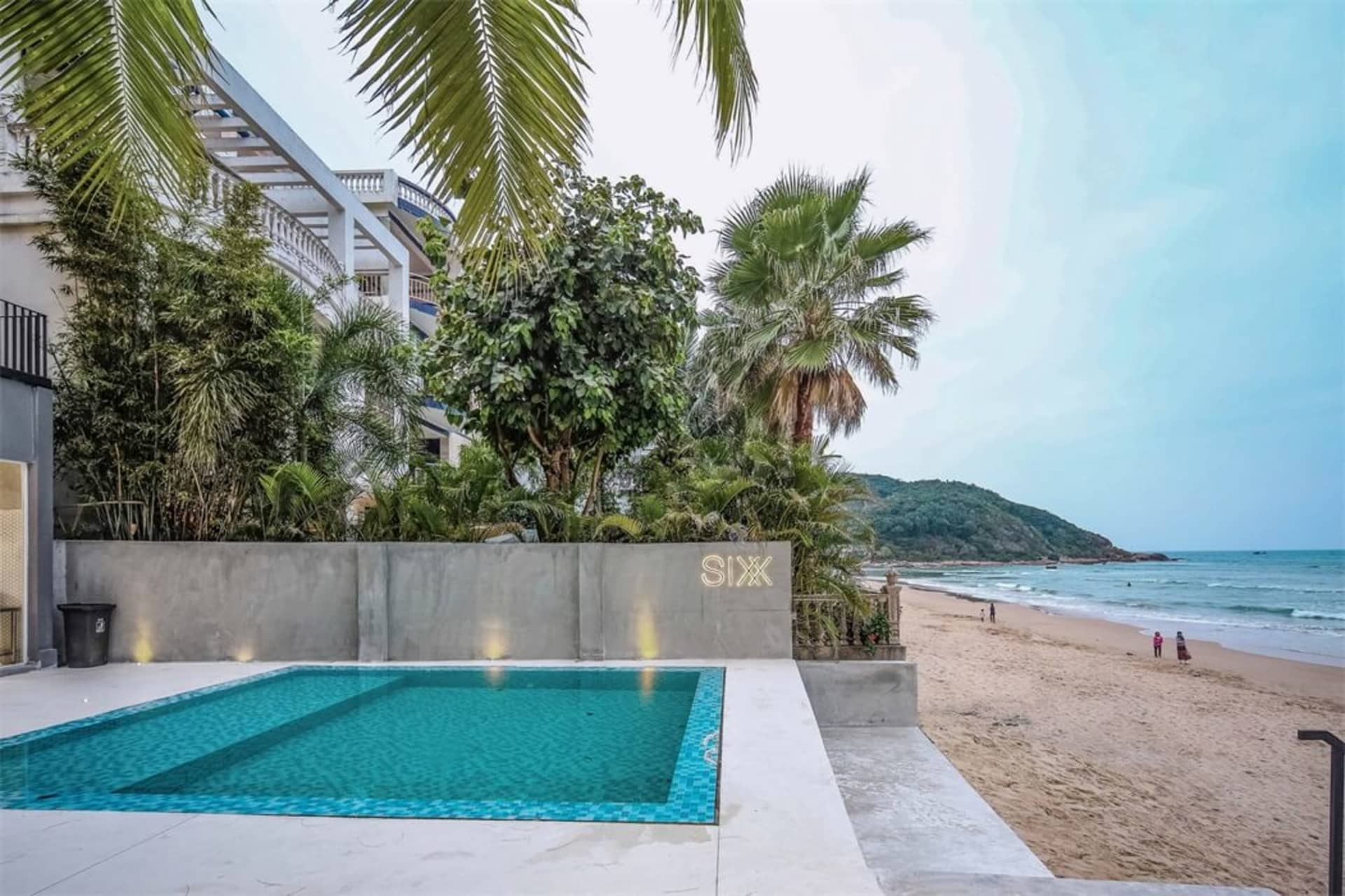 Modern poolside area with concrete and glass elements