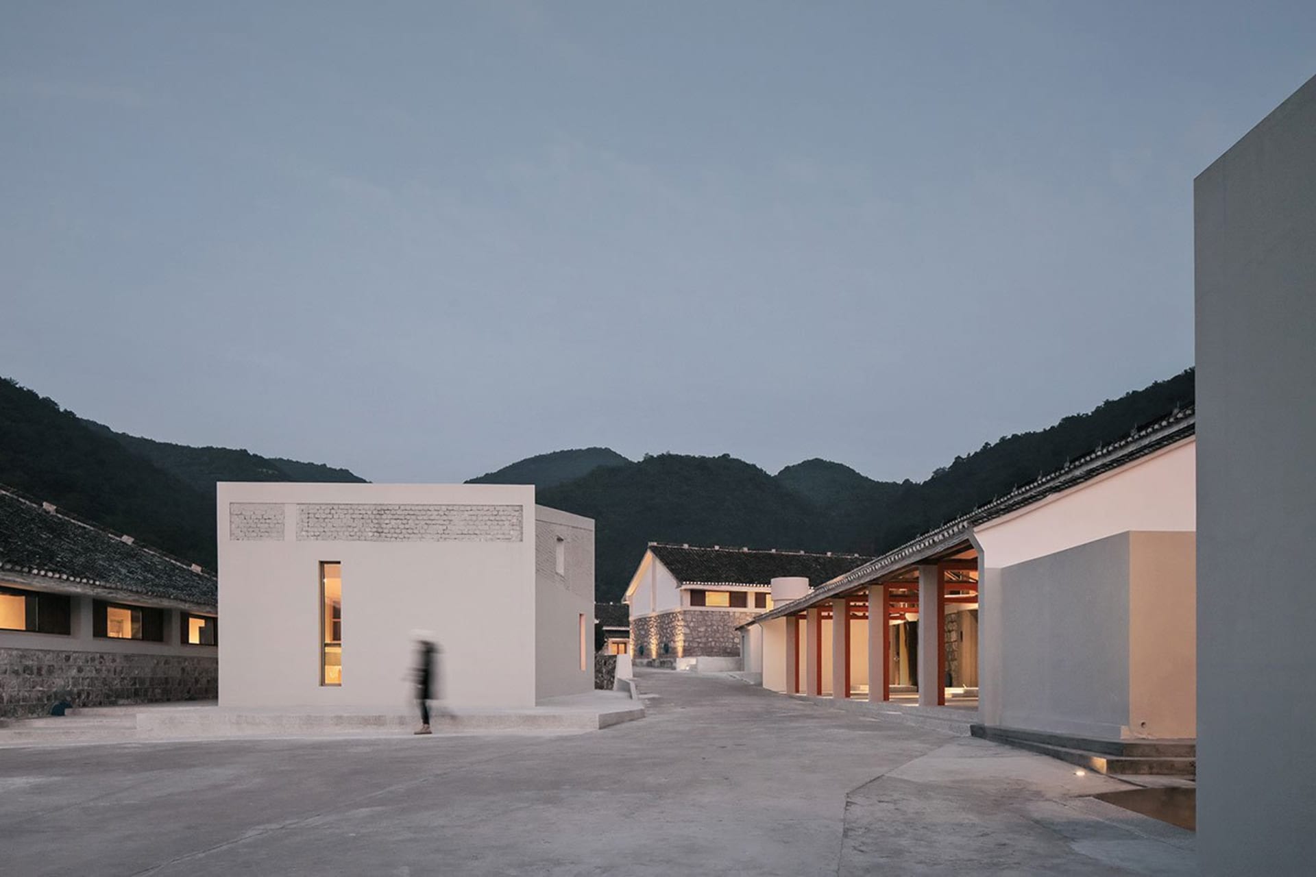 A modern white box building constructed of concrete materials.