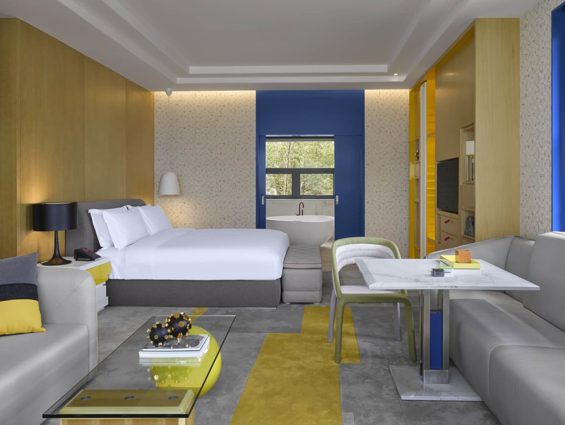 A modern hotel room with concrete walls and a minimalist design.