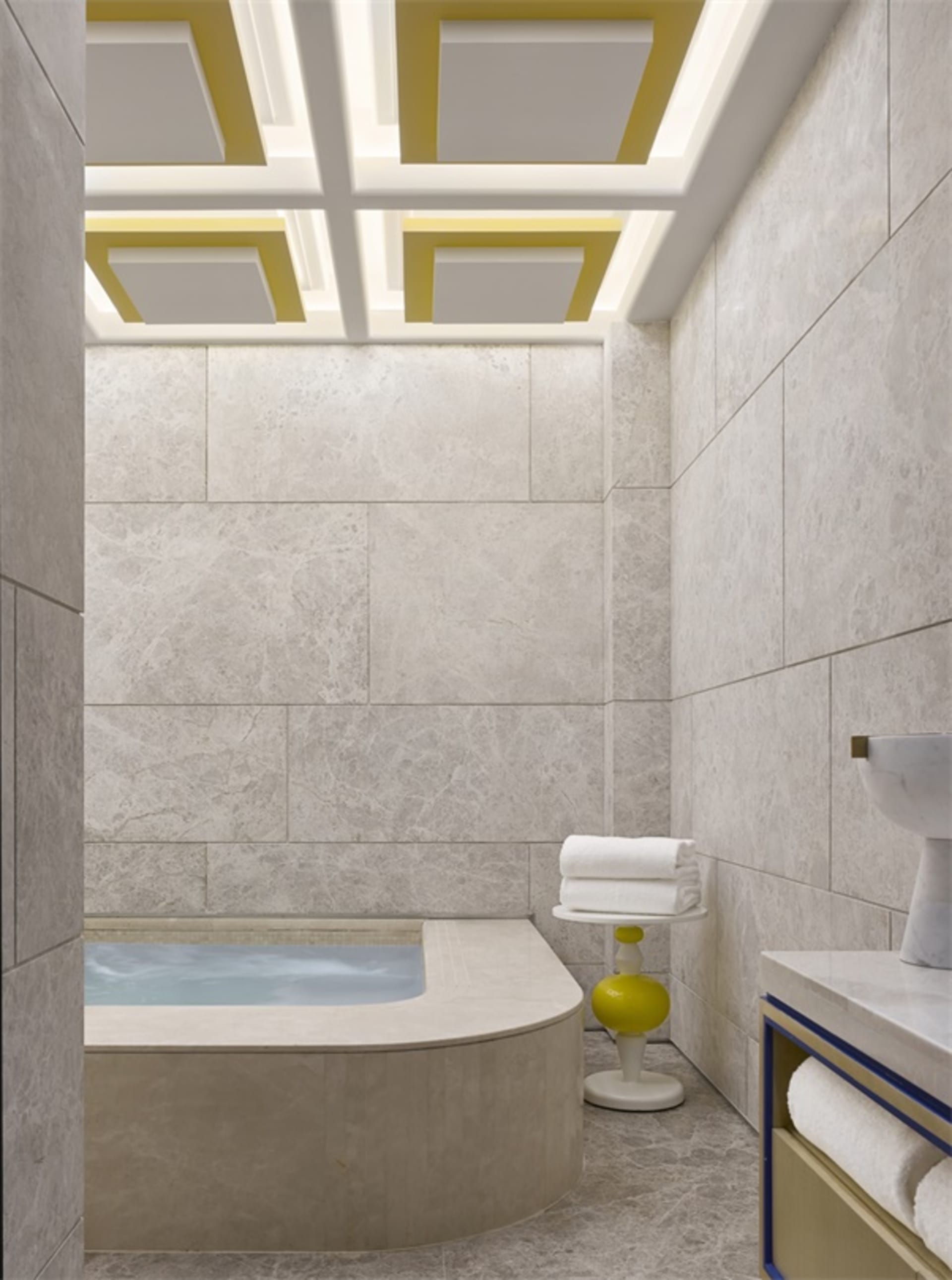 Modern minimalist bathroom featuring a mix of tile materials and a spa-style tub.