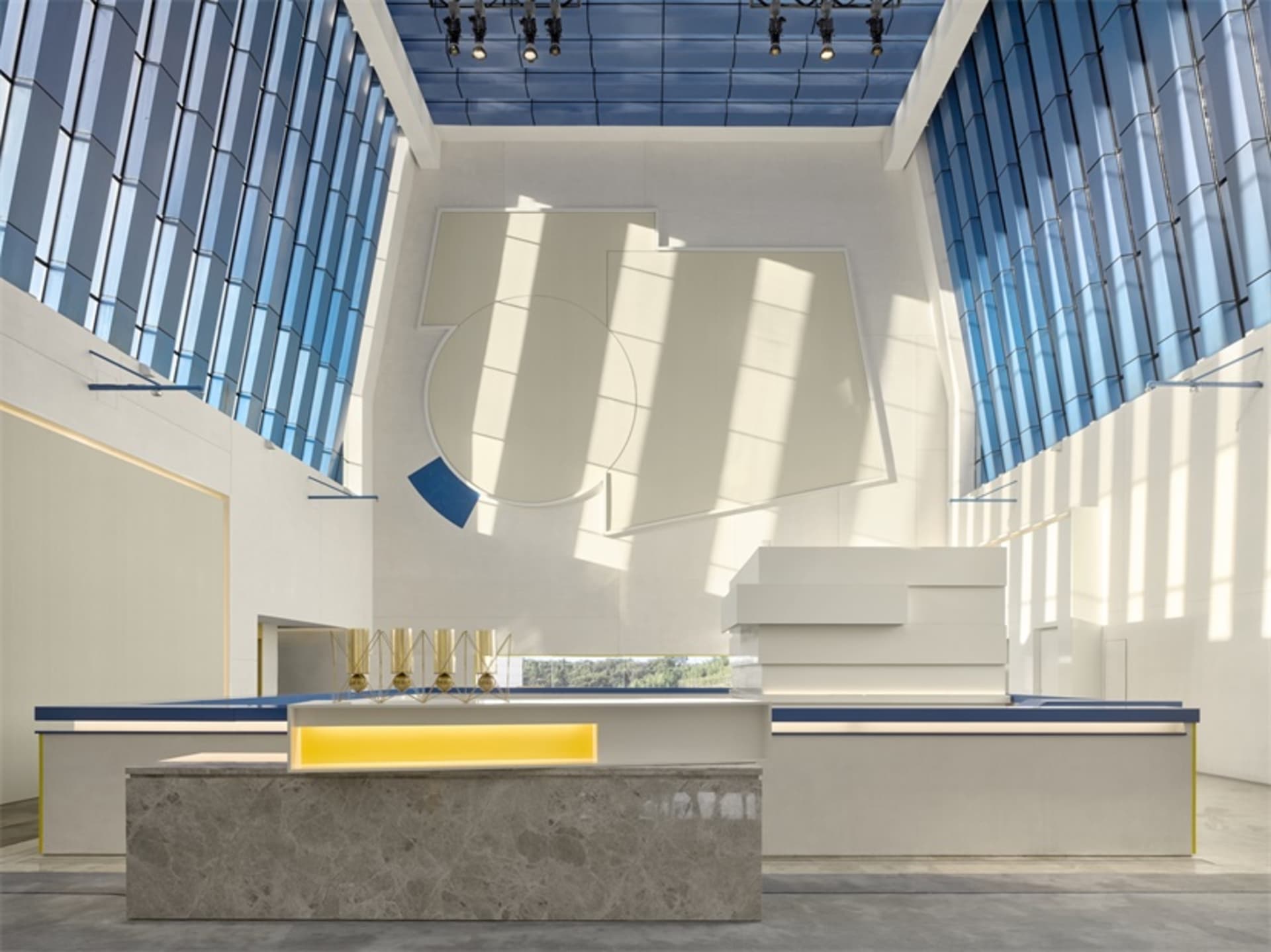 Modern retail shop interior featuring glass walls and marble accents.