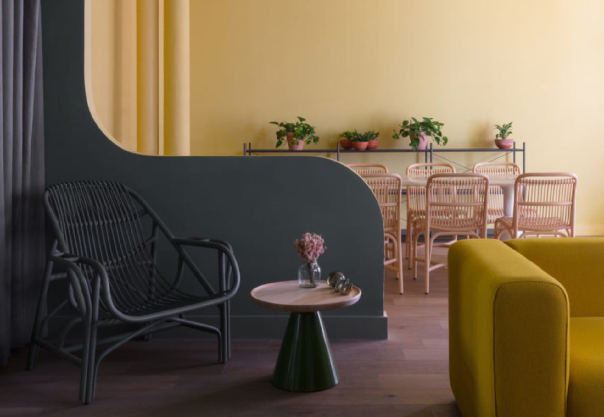 Rattan dining chairs and table in a yellow-themed casual dining room