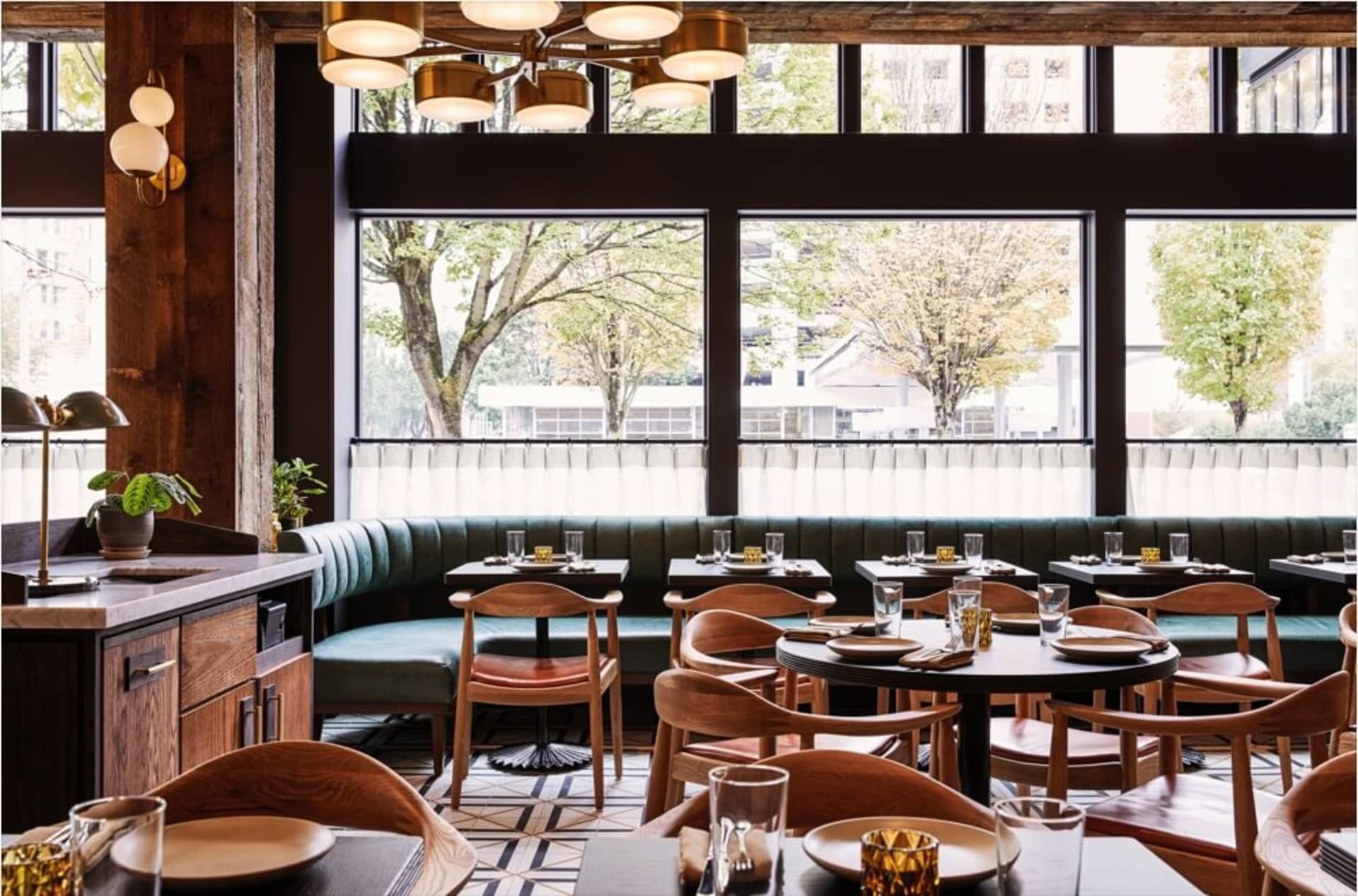 A modern, industrial-styled restaurant interior with wood, leather, and metal materials.