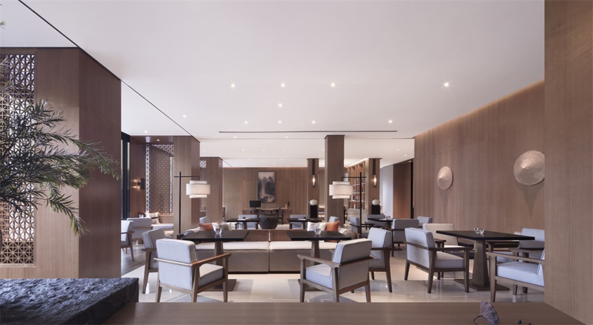 A modern hotel lounge featuring a contemporary design with wooden textures.