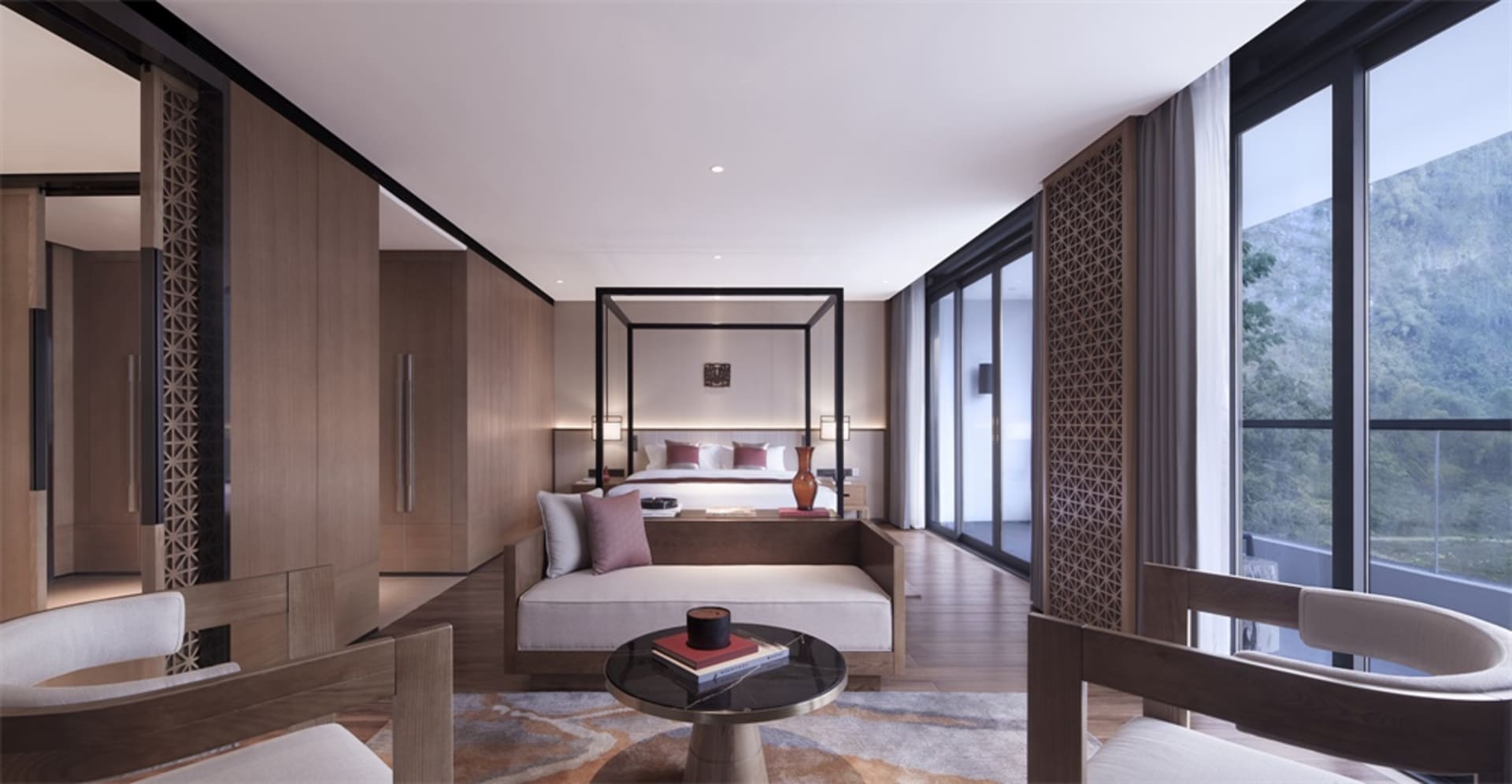 Modern hotel bedroom with wooden furniture and a view of the mountains.