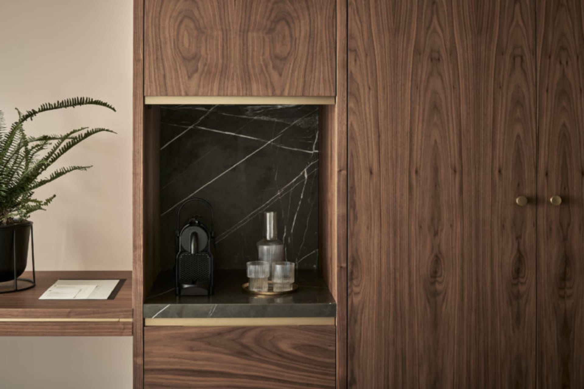 A modern minimalist residential interior with wood, marble, and metal elements.
