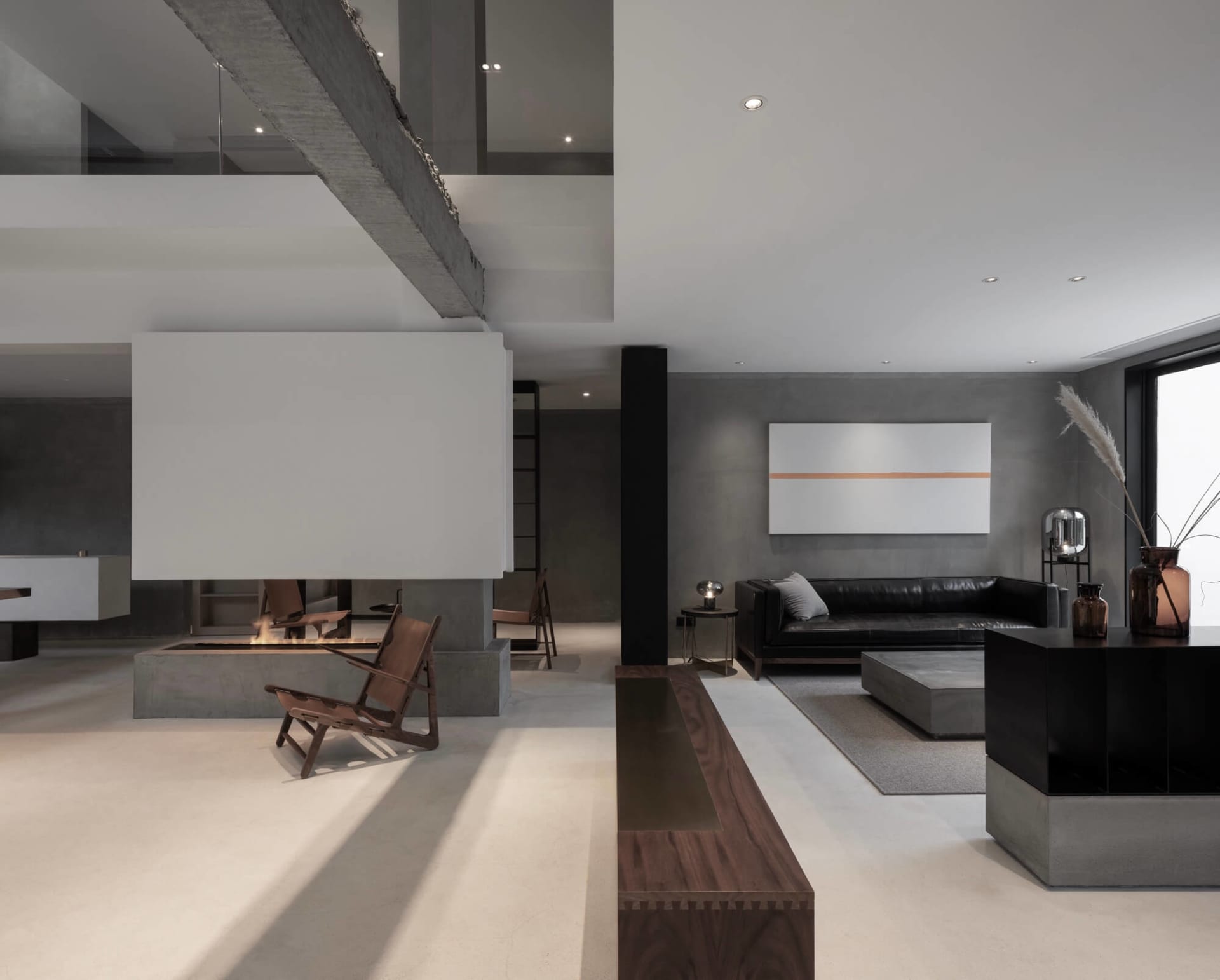 A modern industrial living room featuring a concrete floor, steel beams, a fireplace, and minimalist furniture.