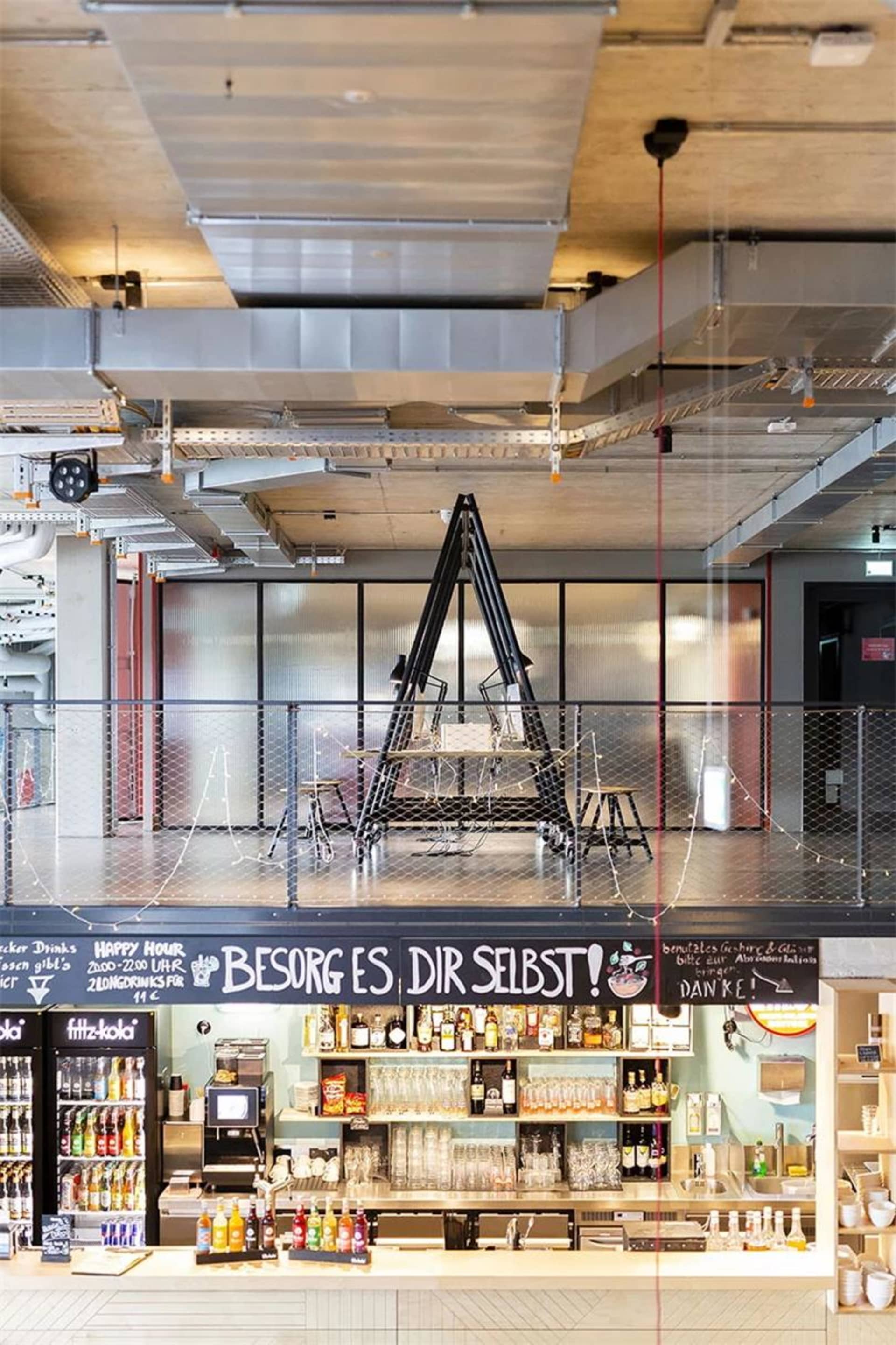 A modern industrial-style coffee shop with metal and glass elements