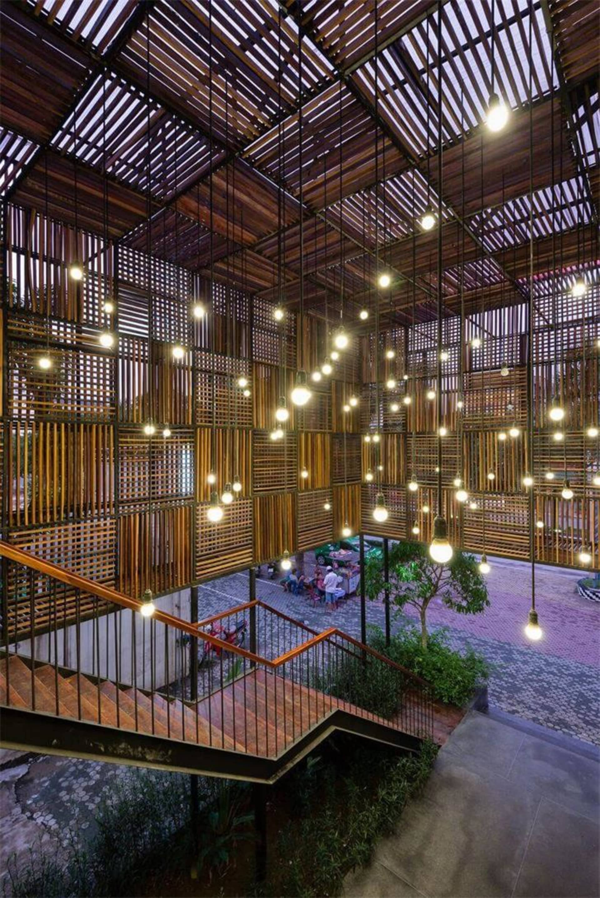 A modern lobby with a brick ceiling featuring exposed wooden beams and pendant lights.