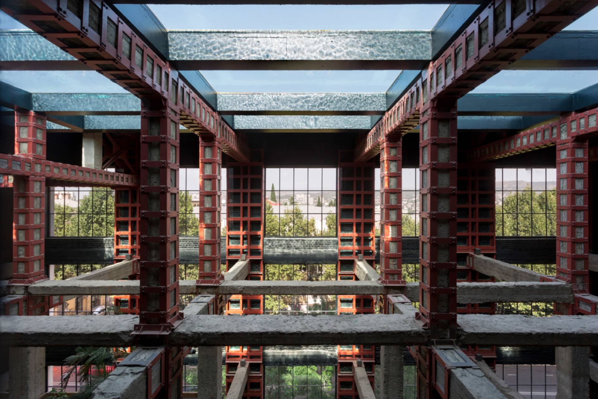A modern interior with glass panels and concrete structures.