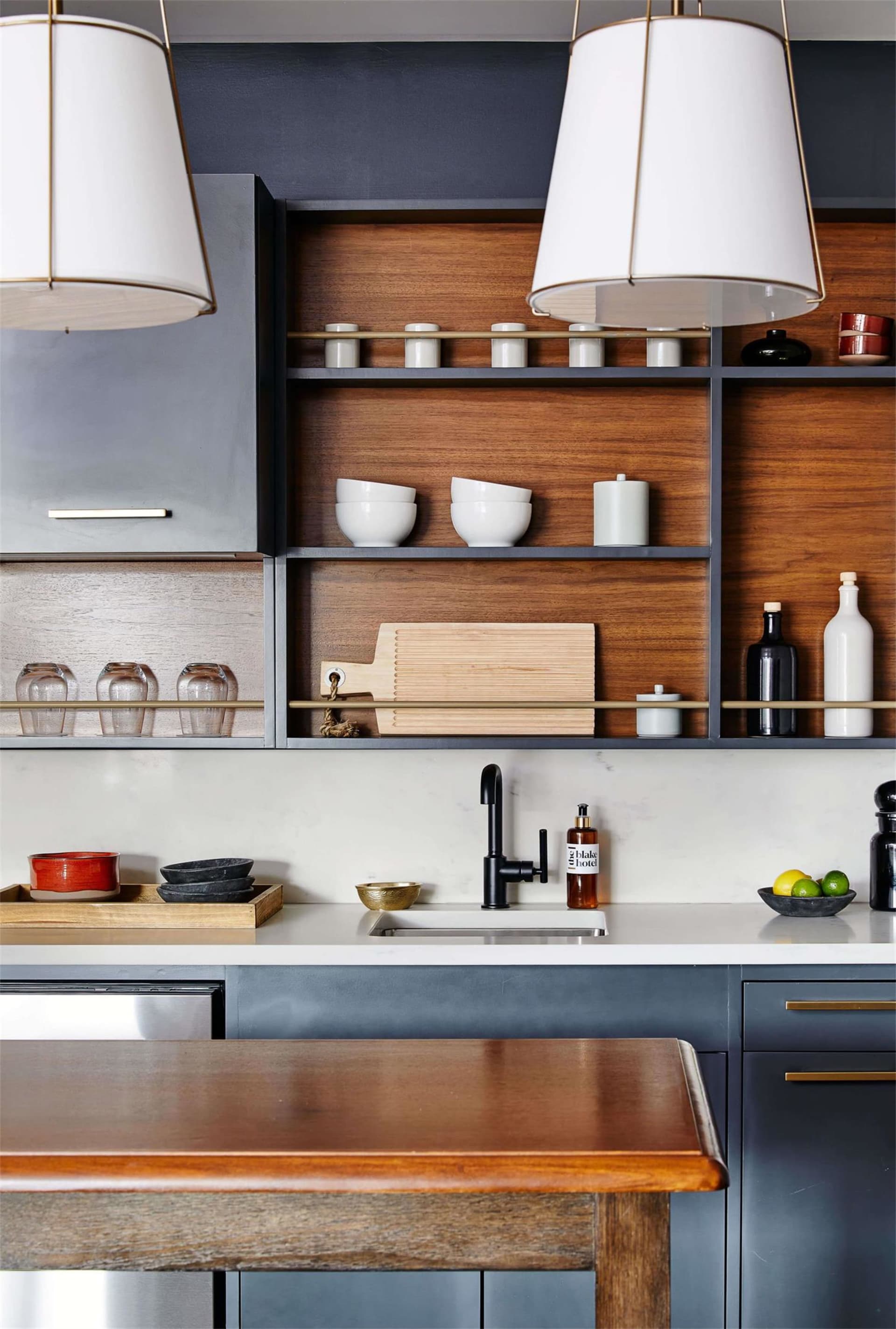 Modern kitchen with open shelving, wood finishes, and stainless steel appliances.