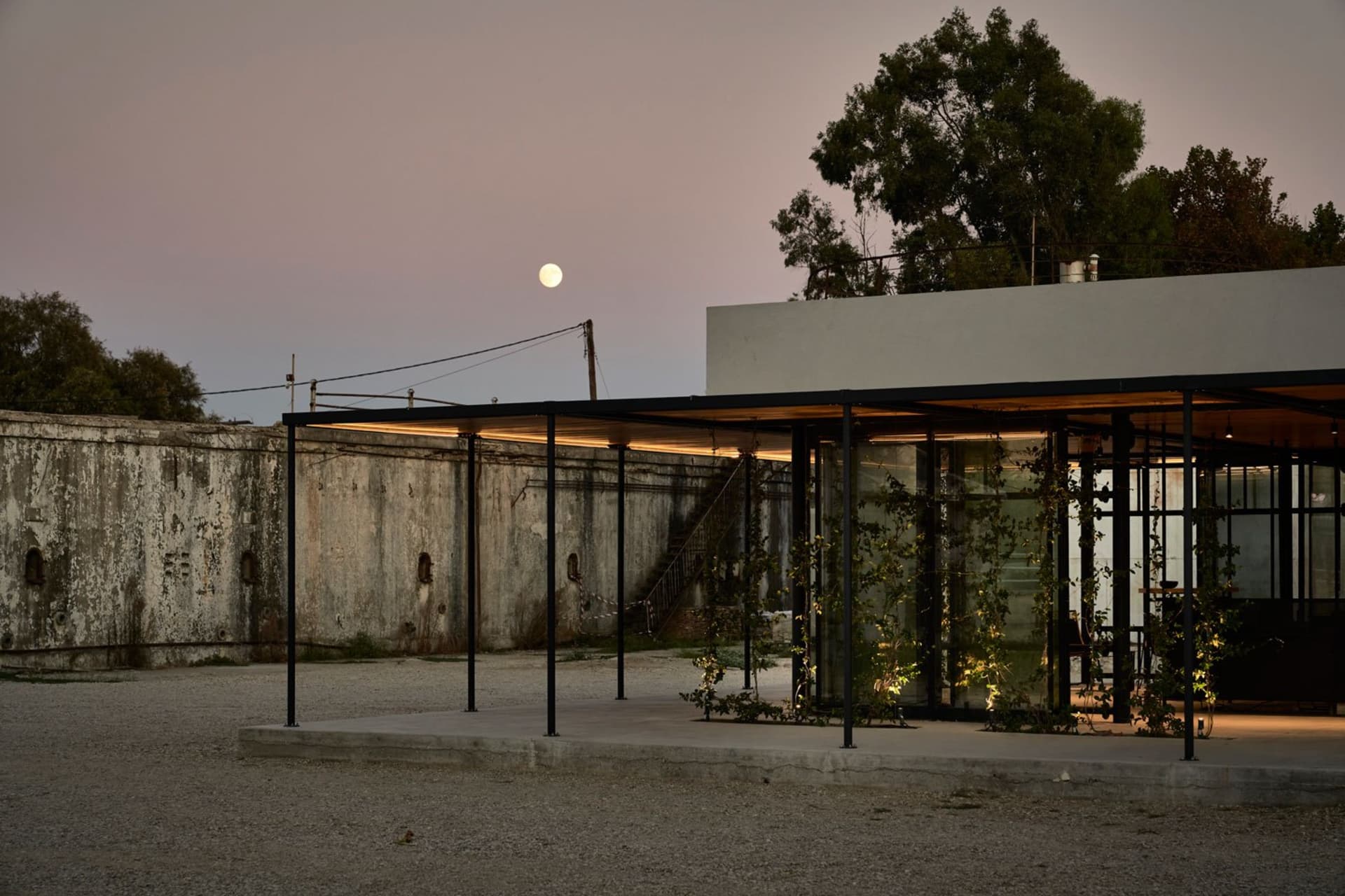 A minimalist residential structure with a concrete facade and a modern architectural design.