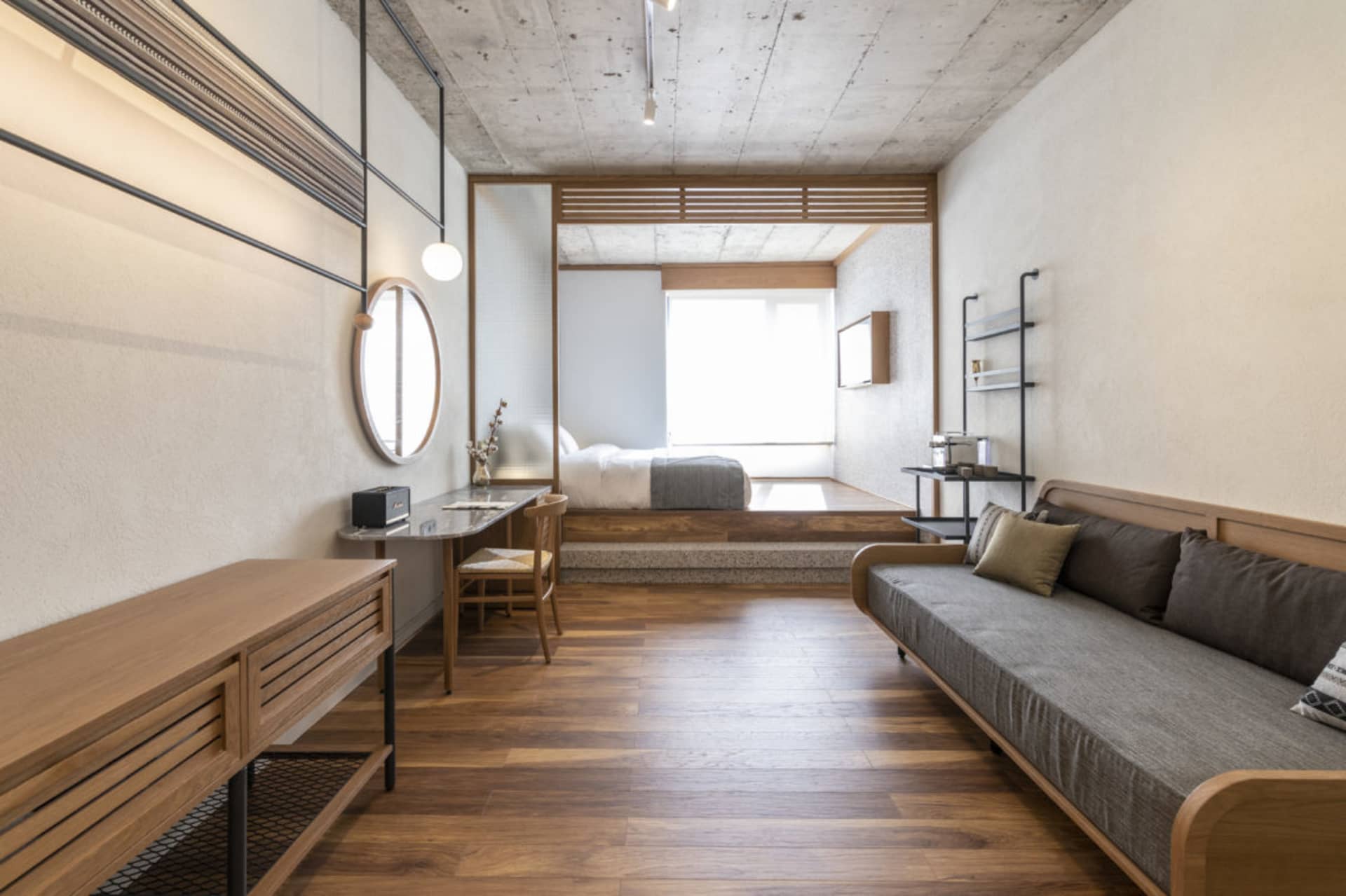 A modern bedroom featuring wooden furniture and minimalist design.