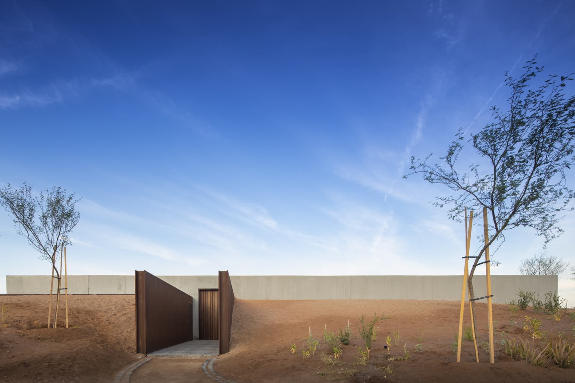 A modern building exterior with a concrete facade viewed outdoors.