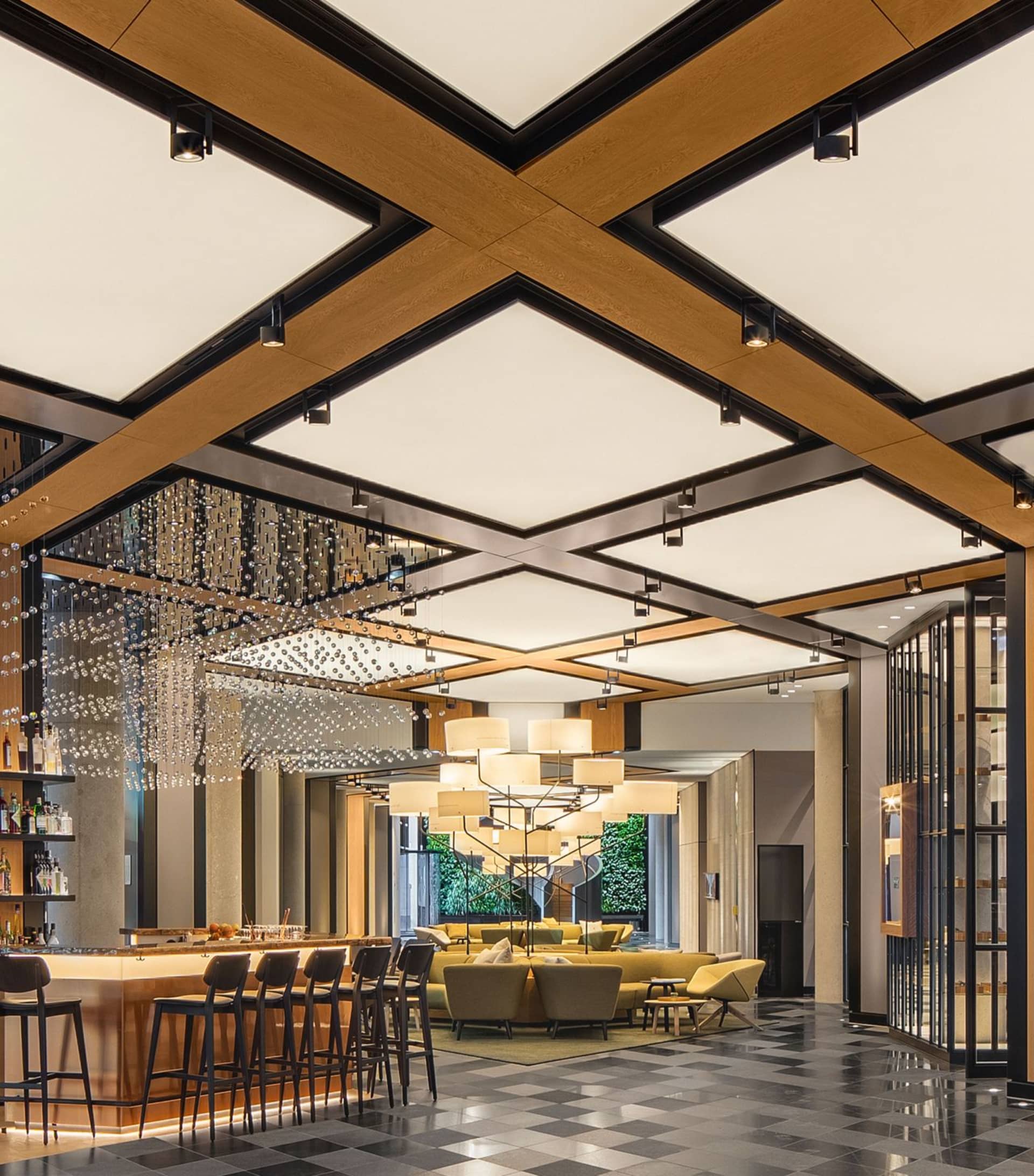 A modern hotel lobby featuring a wooden ceiling design and seating area.