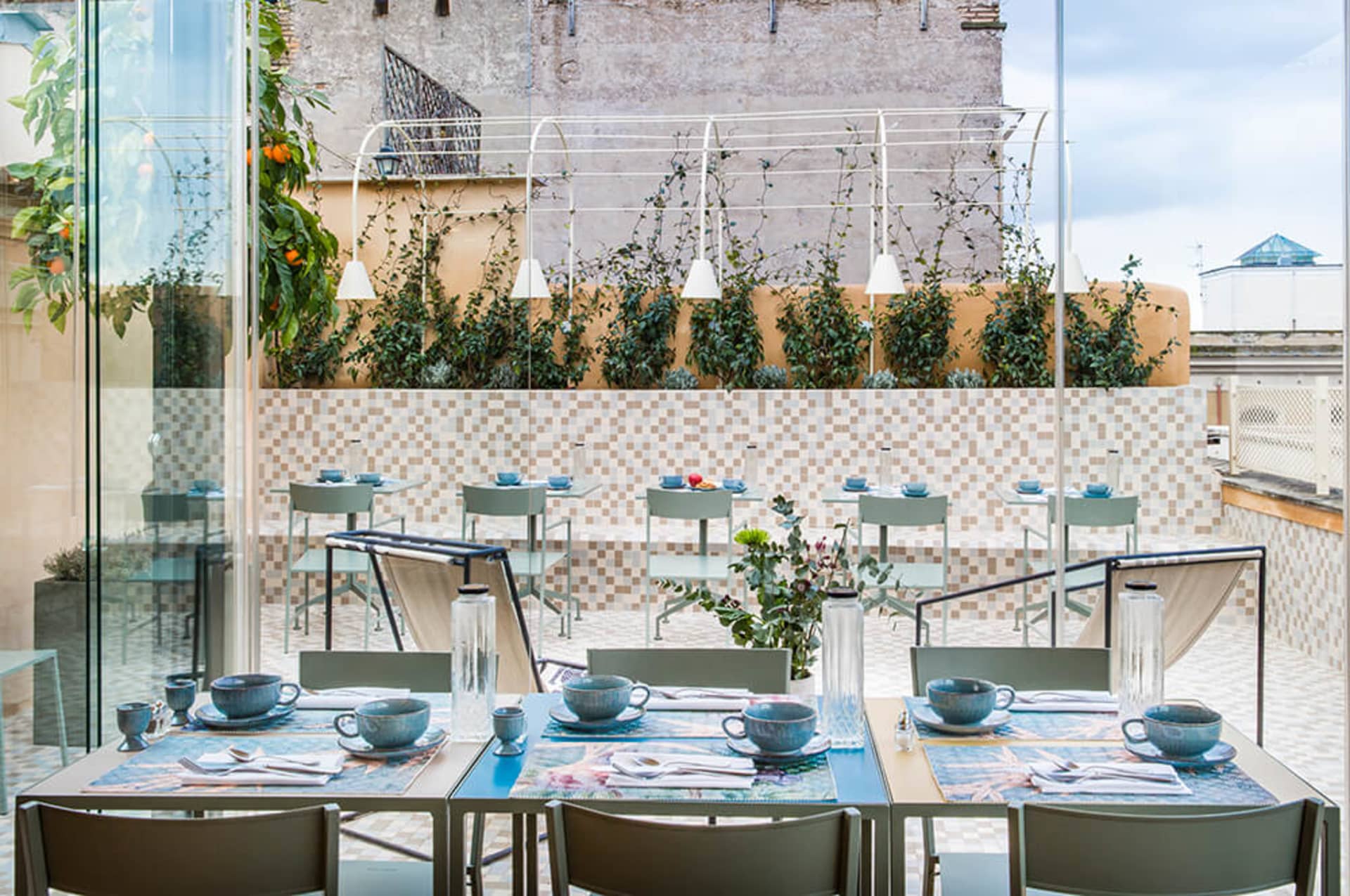 Modern restaurant interior featuring metal, glass, and concrete elements.
