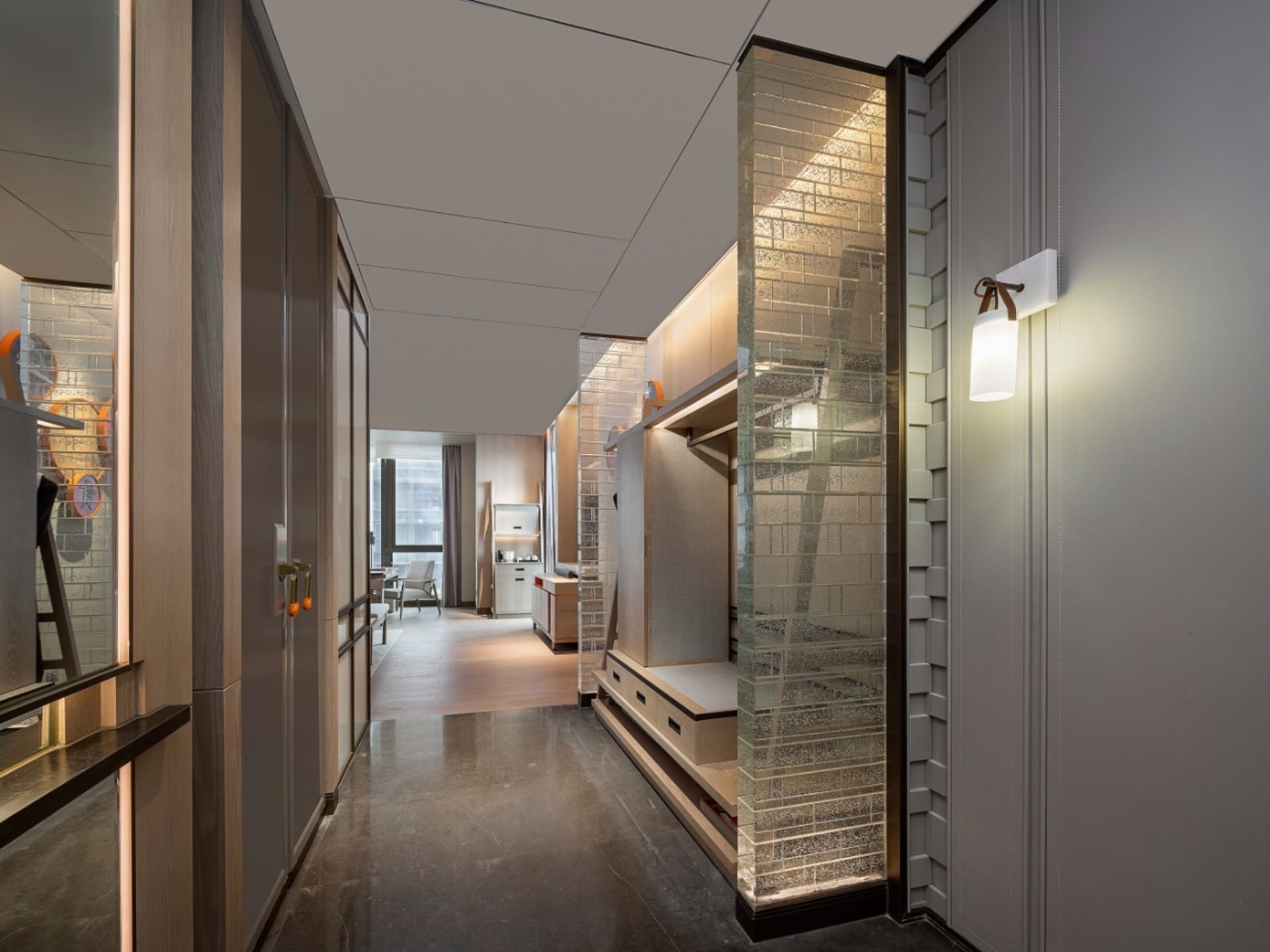 A modern living room features metallic glass and brick storage solutions.