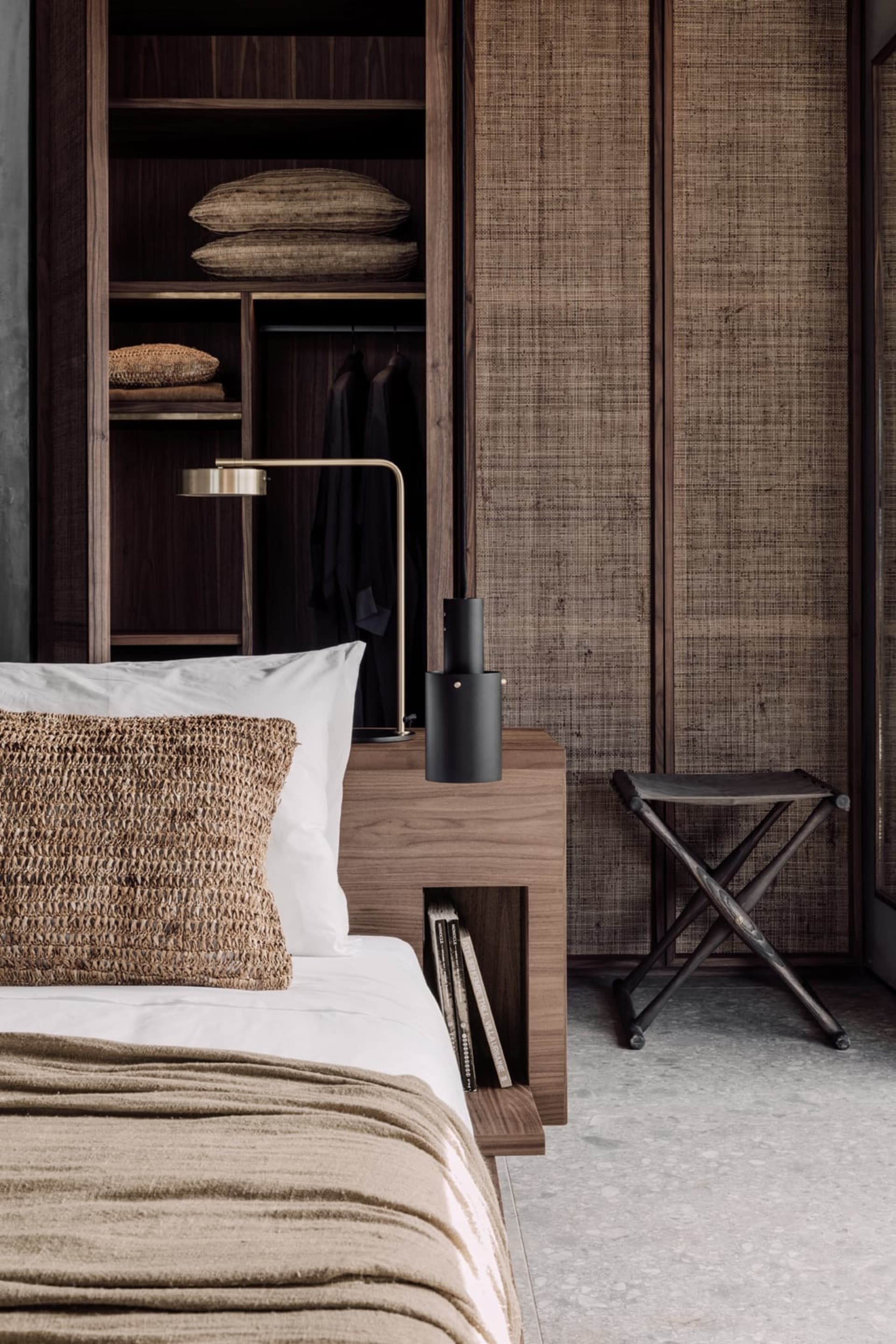 A bedroom featuring bamboo wooden elements, including a bed with bamboo headboard and woven bamboo pillow, and a bedside tabl
